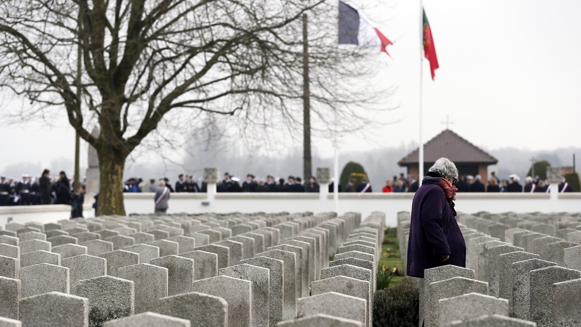 epa06656823 A woman walks between graves at the Portuguese National Cemetery of Richebourg, northern France, 09 April 2018. French President Emmanuel Macron, Portugal&#039;s President Marcelo Rebelo de Sousa and Prime Minister Antonio Costa attend a ceremony to commemorate the 100th anniversary of the Lys Battle and to honor the Portuguese soldiers of the Great War.  EPA/ETIENNE LAURENT