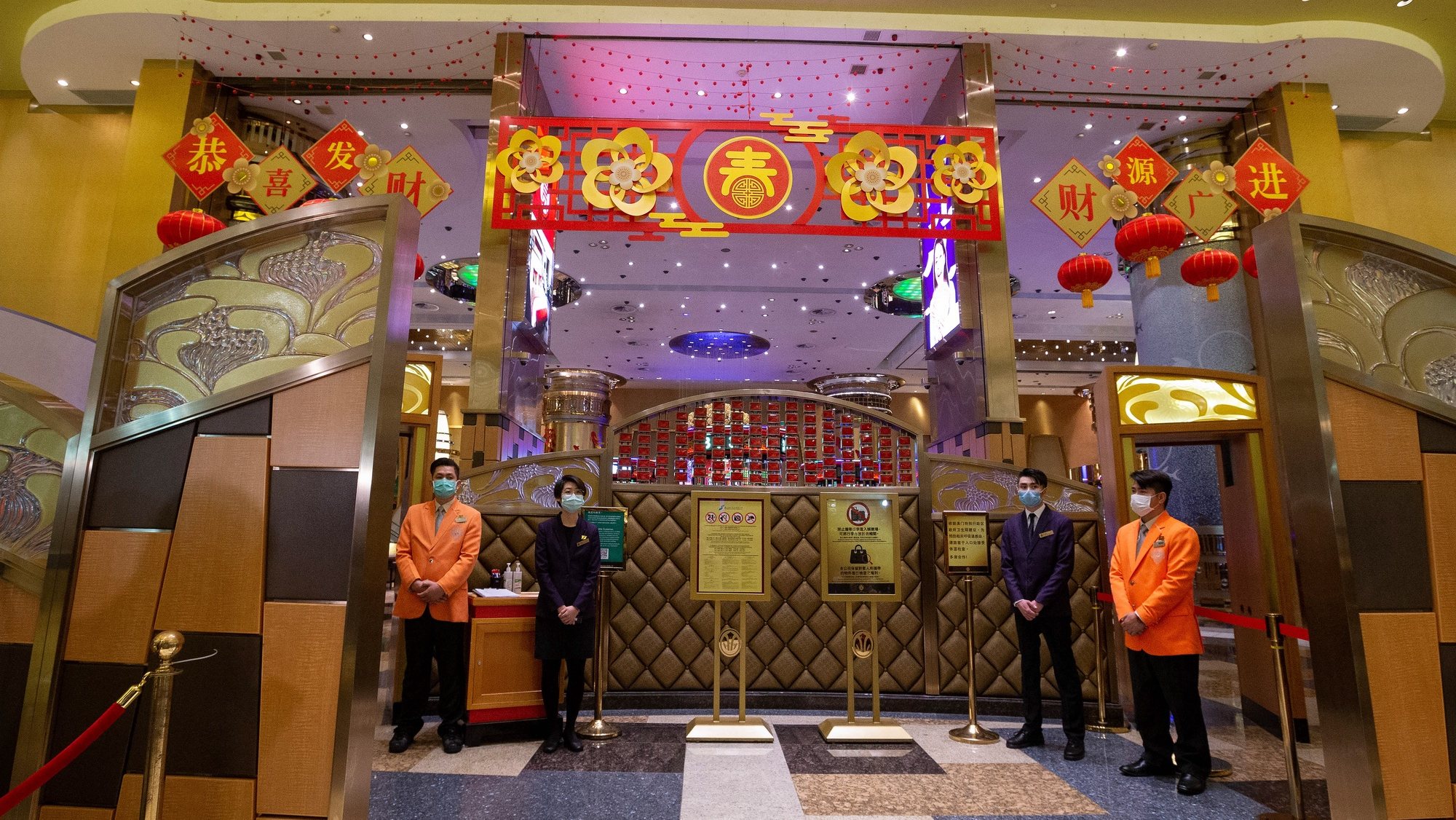 epa08228734 Casino workers wearing protective masks await customers as the Casino reopens in Macao, China, 20 February 2020. Twenty-nine casinos are to reopen starting 20 February, and 12 remain closed, the authorities of the gambling capital said, one of the regions that have identified cases of infection by the coronavirus Covid-19.  After 15 days of closure, Macau&#039;s government said on 17 February that the casinos could reopen, giving operators 30 days to return to business.  EPA/CARMO CORREIA