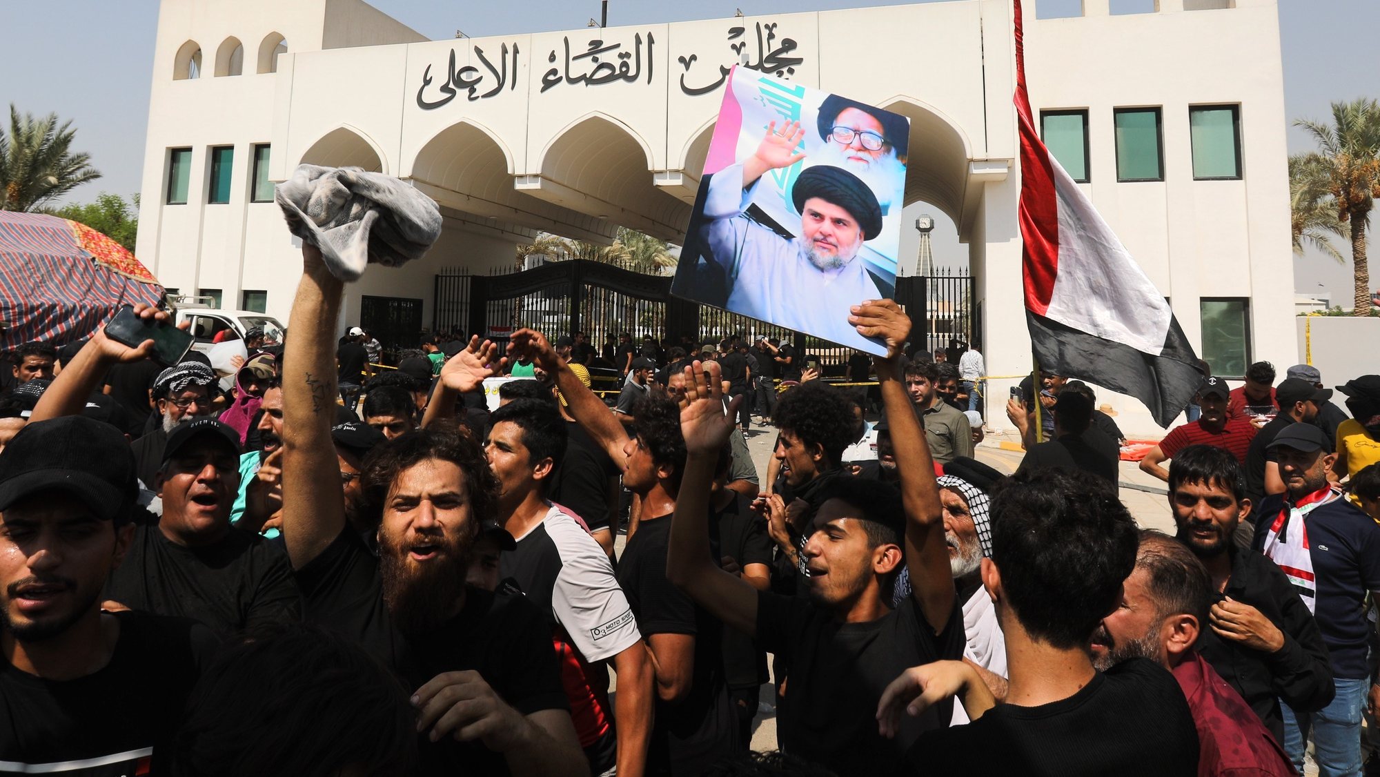 epaselect epa10134469 Supporters of Iraqi Shiite cleric Muqtada al-Sadr, head of the Sadrist movement carry his picture in front of the Supreme Judicial Council, Baghdad, Iraq, 23 August 2022. Supporters of Iraqi Shiite leader Muqtada al-Sadr gathered for a protest and sit-in in front of the Supreme Judicial Council demanding the dissolution of the parliament. They also continue a sit-in at the parliament that began on 30 July, while Supporters of the coordination framework gathered to protest against the rival Sadr&#039;s followers and calling for forming a new government after October legislative elections.  EPA/AHMED JALIL