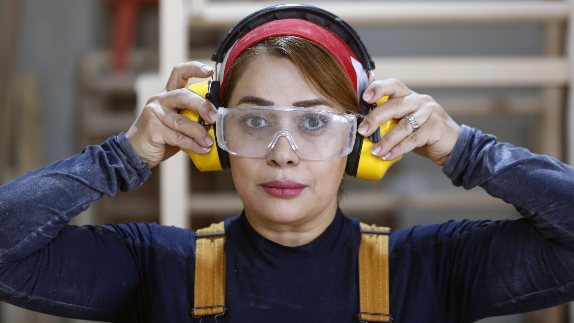 epa10604566 Iranian woman carpenter Sahar Biglari adjusts ear protectors while working at her workshop in Tehran, Iran, 02 May 2023. Biglari, 41, says she left her job as a math and physics teacher to become a carpenter to break the &#039;taboo&#039; as woodworking is traditionally considered to be a male-dominated profession. She has become a social media influencer and a celebrity woodworker. &#039;Most of my followers and students are men now, however when I started my new career I received many negative responses from men, but now they respect me and ask for help&#039;, Sahar says. She is considered to be the first female carpenter in Iran to earn money from the job.  EPA/ABEDIN TAHERKENAREH  ATTENTION: This Image is part of a PHOTO SET