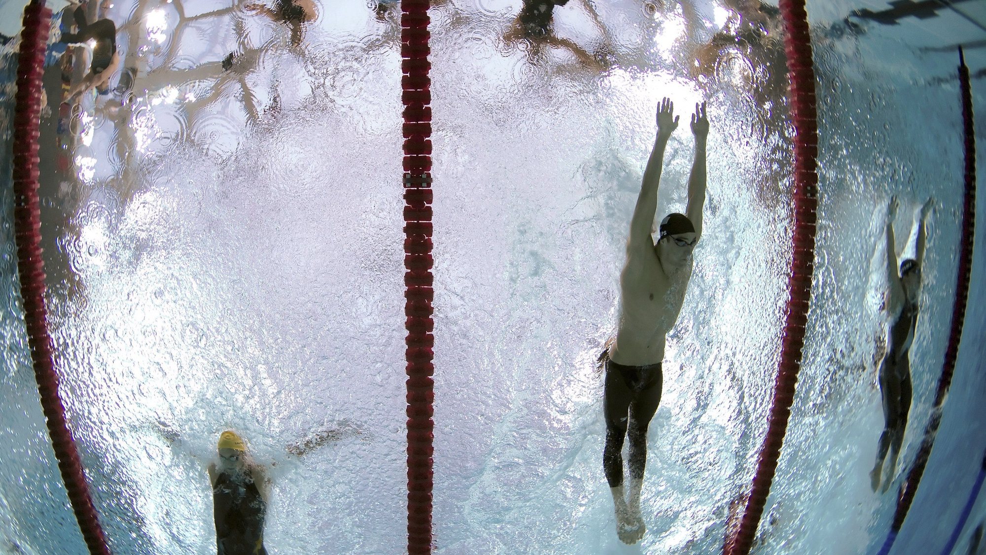 epa01451752 US swimmer Michael Phelps second from R, Australian Andrew Lauterstein (L) and Takuro Fujii from Japan (R)  competes in the butterfly leg of the men&#039;s 4 X 100m medley relay at the National Aquatic Center at the Beijing 2008 Olympic Games, Beijing, China, 17 August 2008. Phelps won his eighth Beijing Olympics gold medal with the teams win which also set a new world record of 3:29.34 allowing Phelps to surpass Mark Spitz&#039;s 1972 Munich games record of seven.  EPA/PATRICK B. KRAEMER