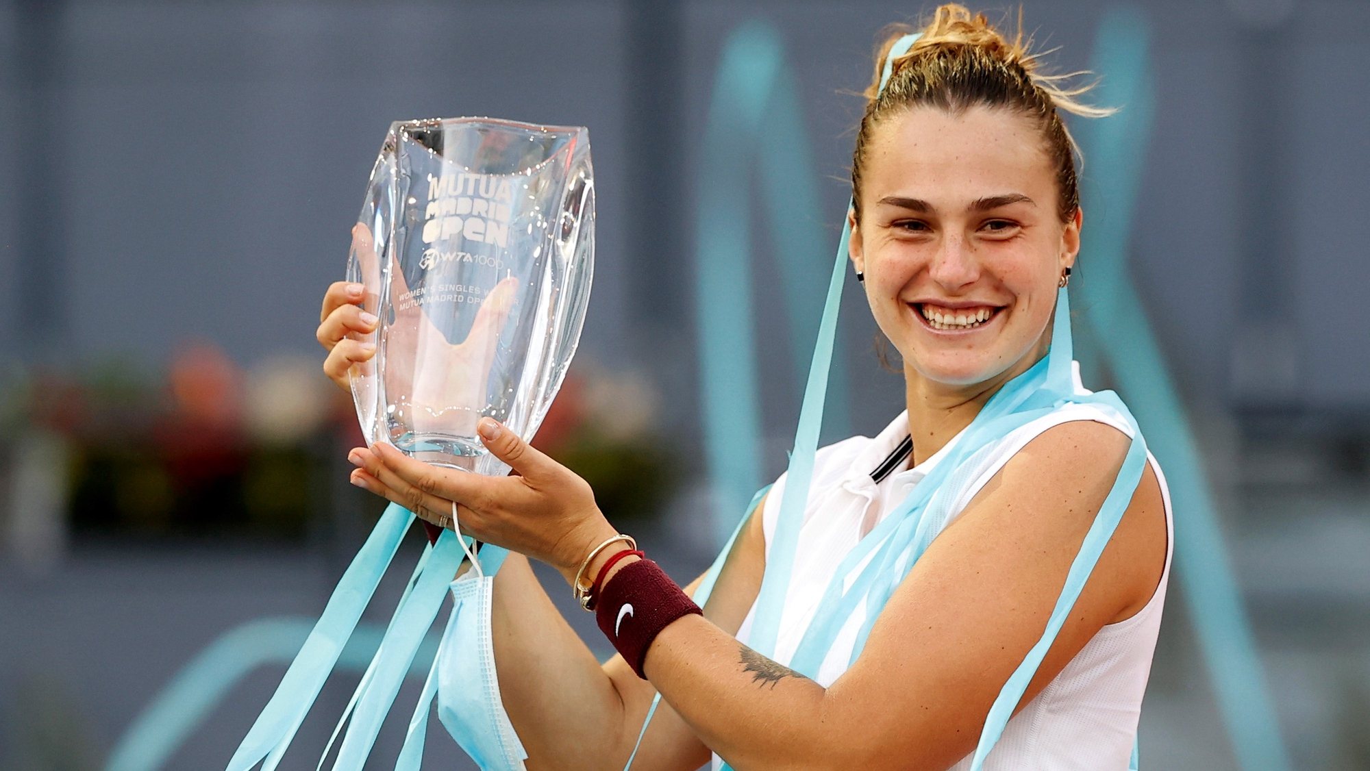 epa09186293 Aryna Sabalenka of Belarus celebrates with her trophy after winning against Ashleigh Barty of Australia in their final match at the Mutua Madrid Open tennis tournament in Madrid, Spain, 08 May 2021.  EPA/CHEMA MOYA