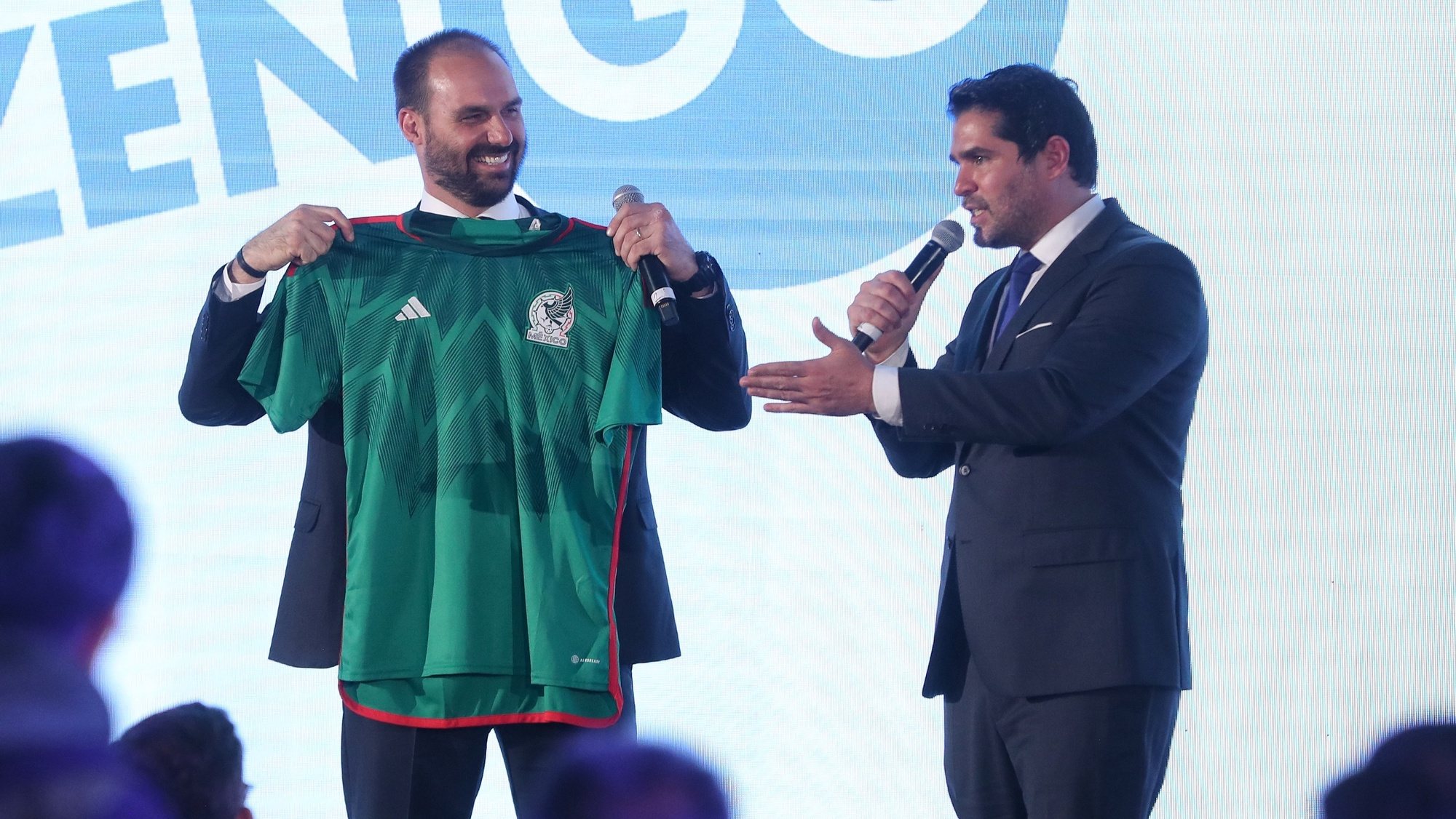 epa10313636 President of CPAC Mexico, Eduardo Verastegui (R), gives a shirt of the Mexican National soccer squad to Brazilian Deputy Eduardo Bolsonaro, son of outgoing President Jair Bolsonaro, takes part in the Conservative Political Action Conference in Mexico City, Mexico, 18 November 2022. Within the framework of the Conservative Political Action Conference (CPAC), Bolsonaro warned that communism has not been eradicated in Latin America and trusted that regimes with &#039;politicians who really represent the popular will&#039; will be transitioned.  EPA/Sashenka Gutierrez