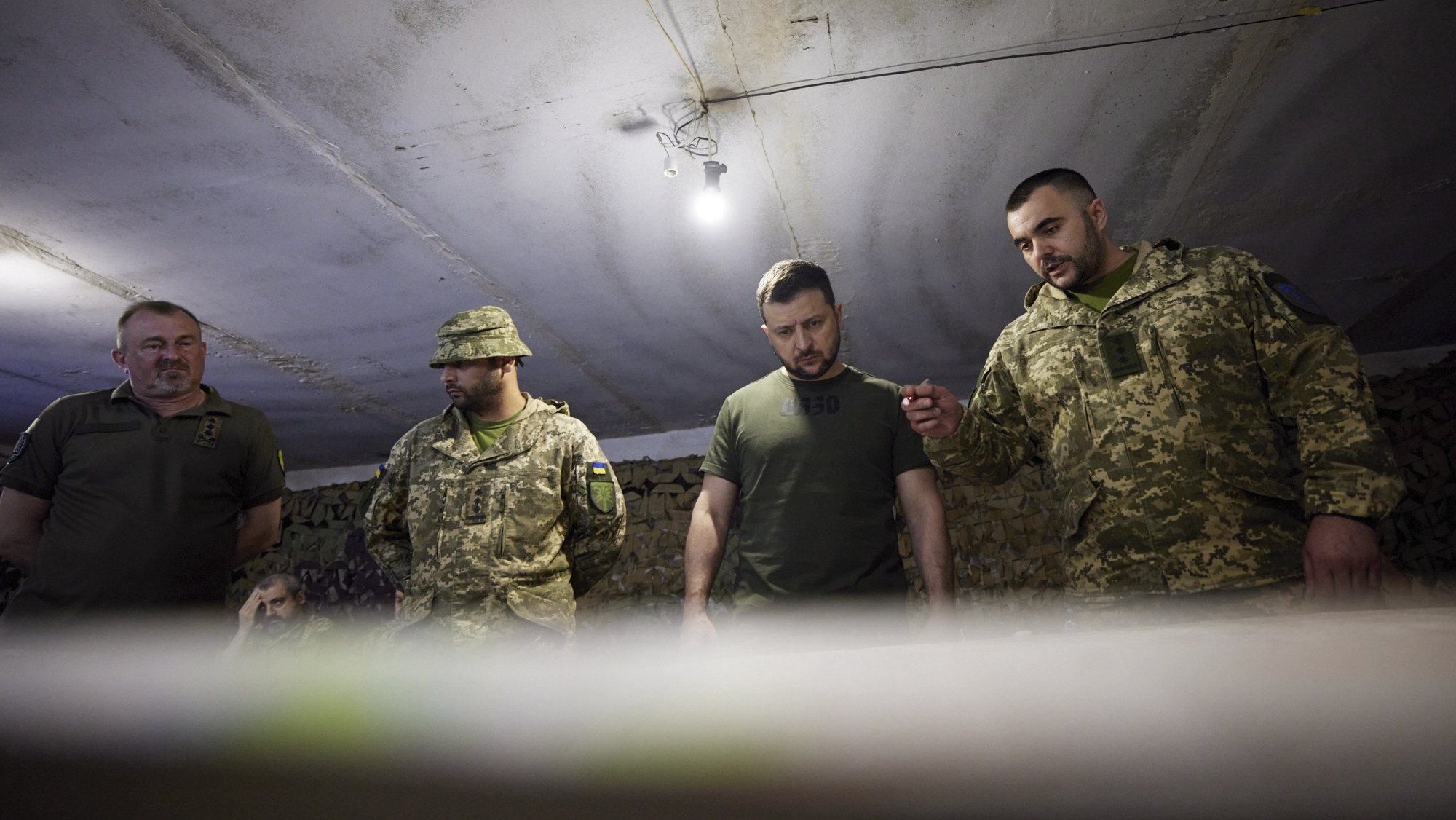 epa09998210 A handout picture made available by the presidential press service shows Ukrainian President Volodymyr Zelensky (C-R) speaking with servicemen during his visit to a frontline in the Zaporizhia area, Ukraine, 05 June 2022. Zelensky got himself updated on the operational situation at the line of defense amid the Russian invasion. Russian troops had invaded Ukraine on 24 February, starting a conflict that provoked fighting, destruction and a humanitarian crisis since.  EPA/PRESIDENTIAL PRESS SERVICE HANDOUT HANDOUT  HANDOUT EDITORIAL USE ONLY/NO SALES