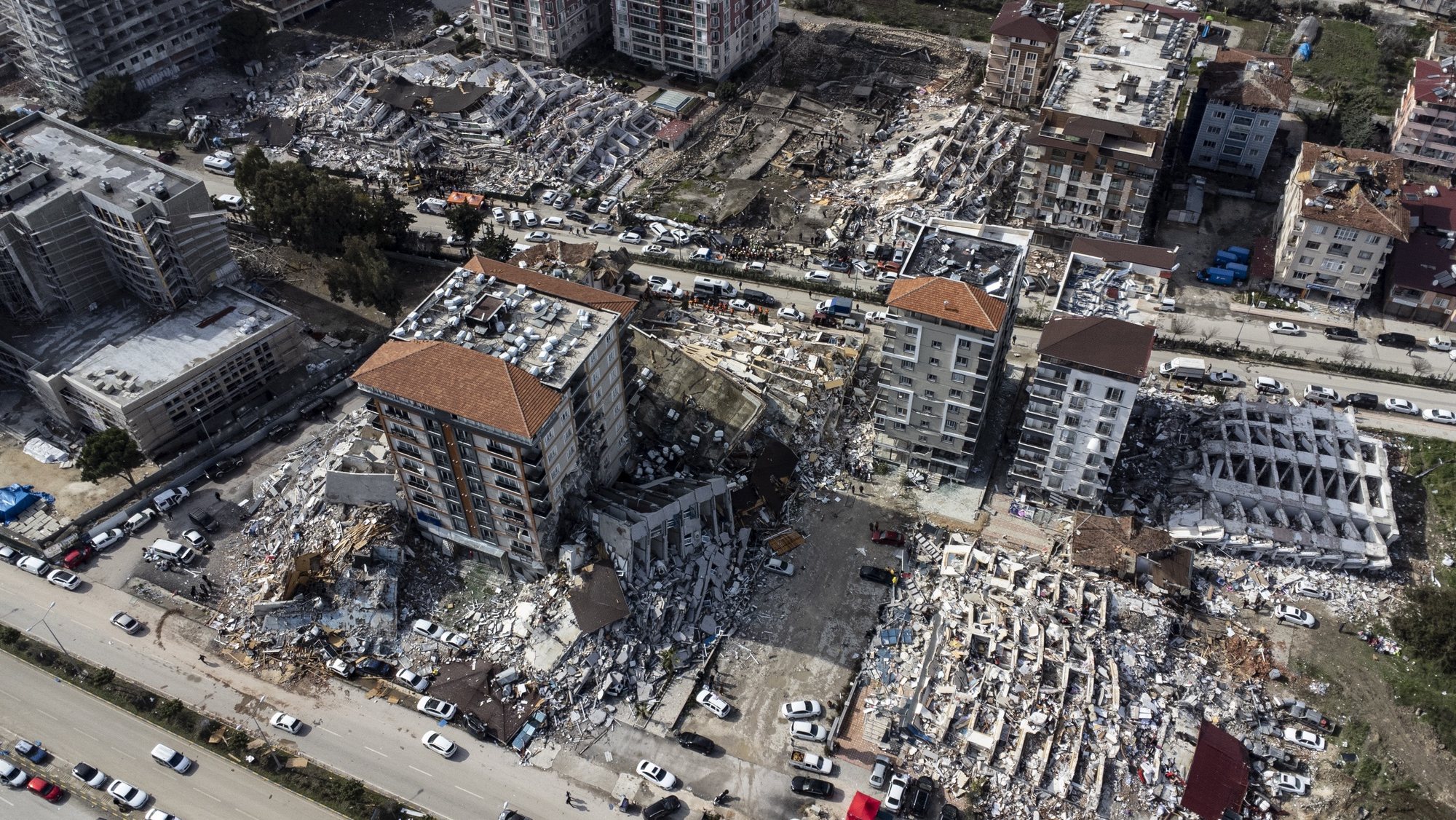 epa10452945 A photo taken with a drone shows a an aerial view over collapsed buildings after an earthquake in Hatay, Turkey, 07 February 2023. Thousands of people died and thousands more were injured after major earthquakes struck southern Turkey and northern Syria on 06 February. Authorities fear the death toll will keep climbing as rescuers look for survivors across the region.  EPA/ERDEM SAHIN