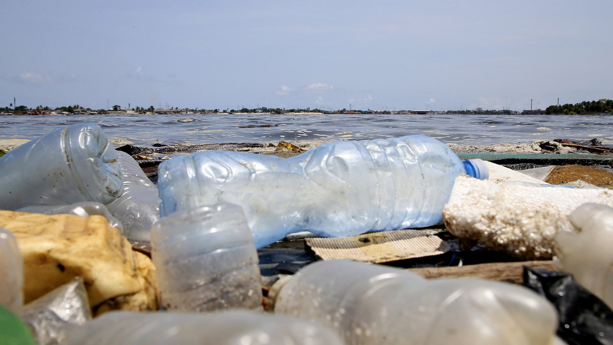 epa09150004 Plastic bottles float on the Ebrie lagoon in the city of Abidjan, Ivory Coast, 21 April 2021. According to the Ivorian Anti Pollution Center (CIAPOL), every day 200 tonnes of solid waste is poured into all of the 8 lagoon bays of Abidjan. This waste is mainly composed of plastics, which have affected the Ebrie lagoon for several decades. This pollution is widespread and will affect environments for hundreds of years. A project has therefore been set up by the Ivorian Antipollution Center (Ciapol) to recover its plastic waste from the water bodies and bring it back to land in order to send it to a treatment or recycling circuit.  EPA/LEGNAN KOULA