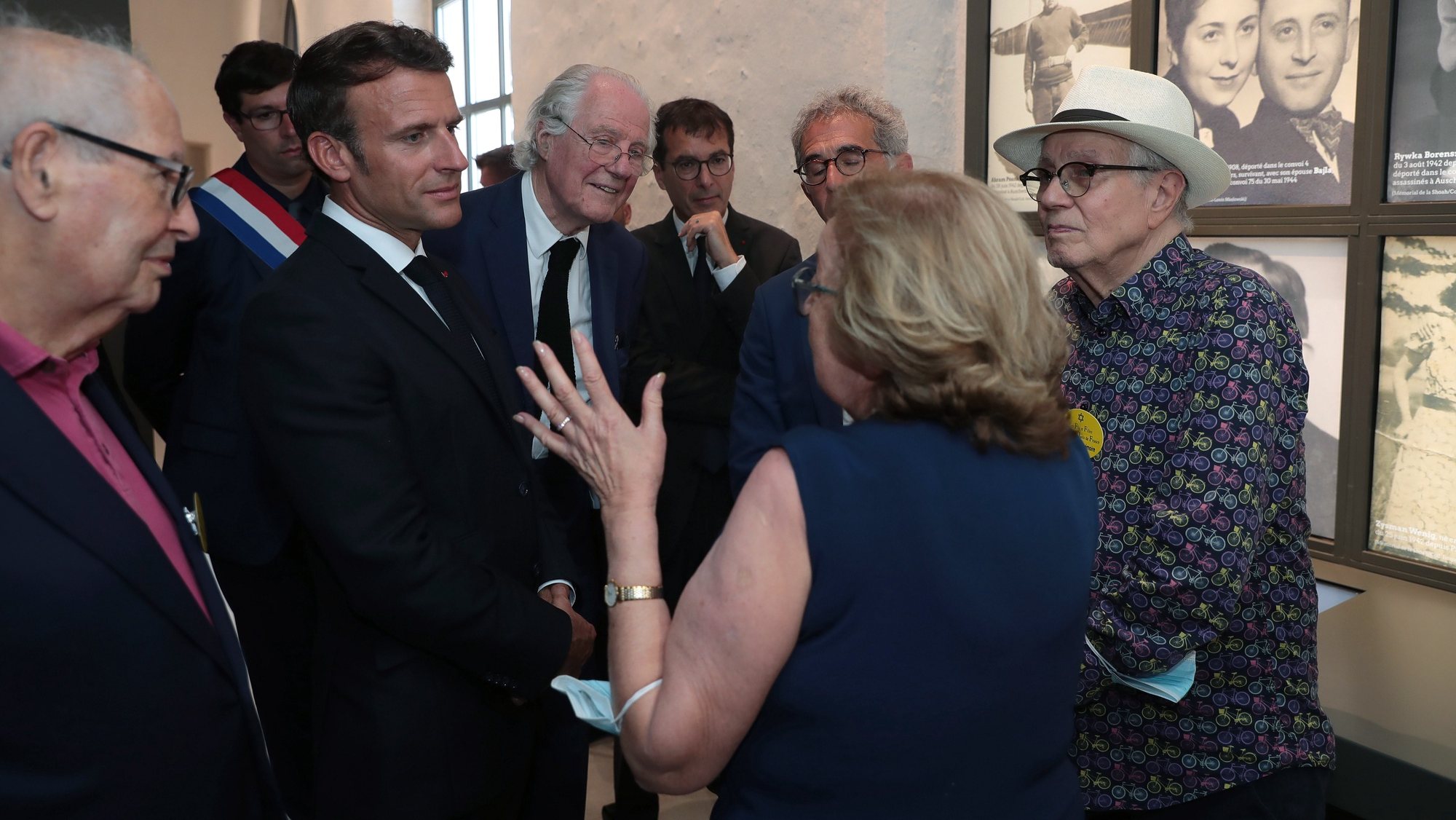 epa10076085 French President Emmanuel Macron (2L) speaks with Shoah survivors Regine Lipp (C-back) and Marcel Sztejnberg (R) during a visit of the newly inaugurated Shoah memorial at the former Pithiviers&#039; train station as part of a ceremony commemorating the 80th anniversary of the Vel d&#039;Hiv roundup in Pithiviers, France, 17 July 2022.  French police rounded up a mass arrest of some 13,000 Jews on July 16-17, 1942 in Nazi-occupied France before they were sent in to camps.  EPA/CHRISTOPHE PETIT TESSON / POOL