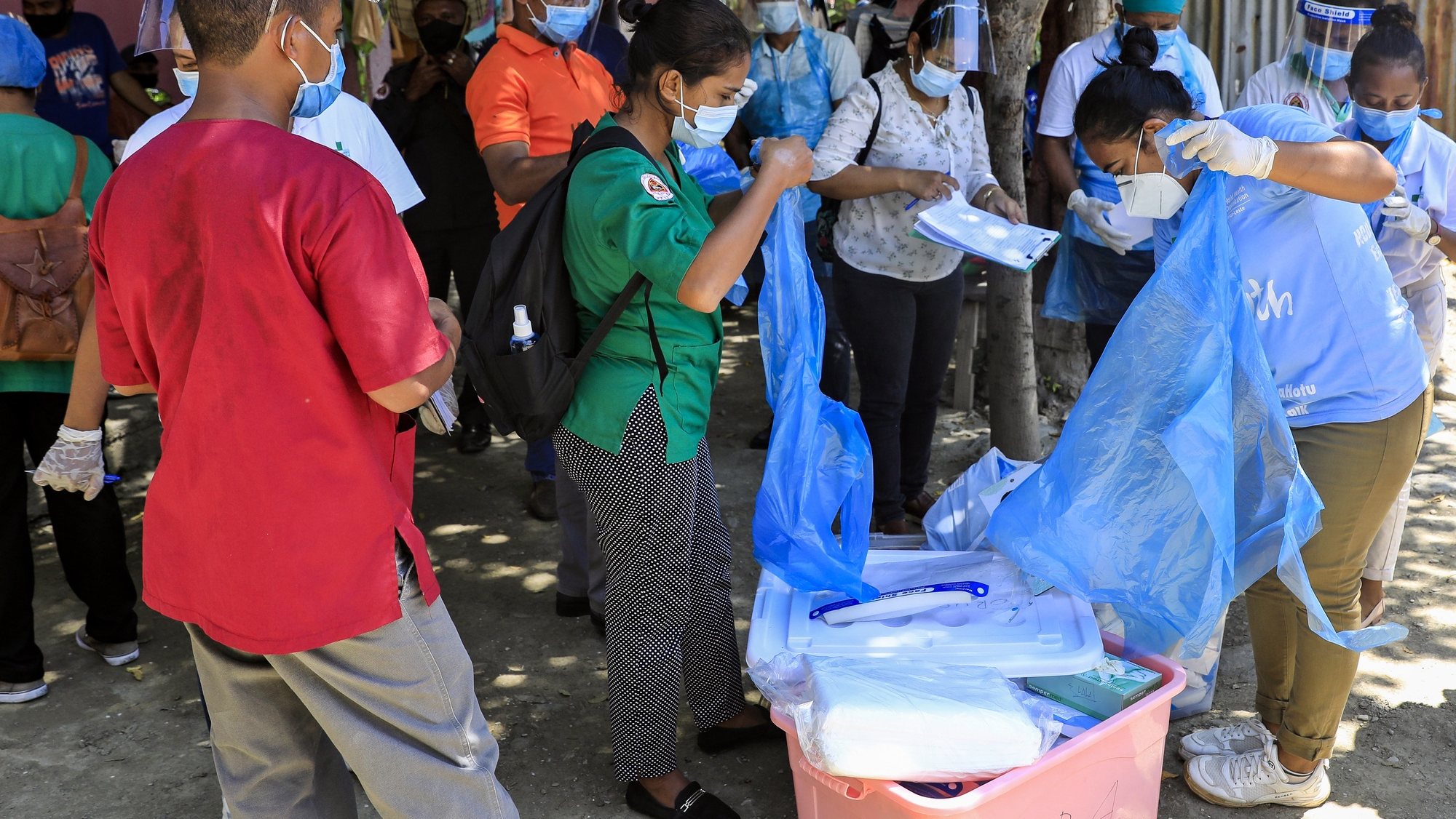 epa09079360 Healthcare workers prepare for a COVID-19 swab test in Dili, East Timor, also known as Timor Leste, 17 March 2021. With less than 300 COVID-19 cases and zero deaths, Timor Leste recorded the second-smallest outbreak in Southeast Asia after Laos. The country imposed a state of emergency a week after the Catholic-majority nation reported its first case on 21 March 2020, and enforced strict border controls.  EPA/ANTONIO DASIPARU