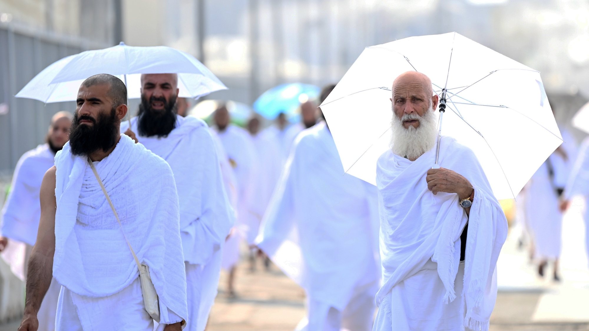 epa11409862 Muslim pilgrims make their way to the Mina tent camp for the start of the Hajj 2024 pilgrimage, in Mecca, Saudi Arabia, 14 June 2024. Pilgrims began arriving in Mina on 14 June for performing the Hajj 2024 rituals, taking place this year from the evening of 14 June until 19 June. Saudi authorities said that over 1.5 million pilgrims are expected in Saudi Arabia for this year&#039;s Hajj season. Muslims attending this year&#039;s Islamic Hajj pilgrimage will face the challenge of a significant rise in temperatures, which poses a threat to the health of pilgrims, according to the Ministry of Health statement, as the National Center for Meteorology (NCM) expected temperatures to range between 45 and 48 degrees Celsius at the holy sites.  EPA/STRINGER