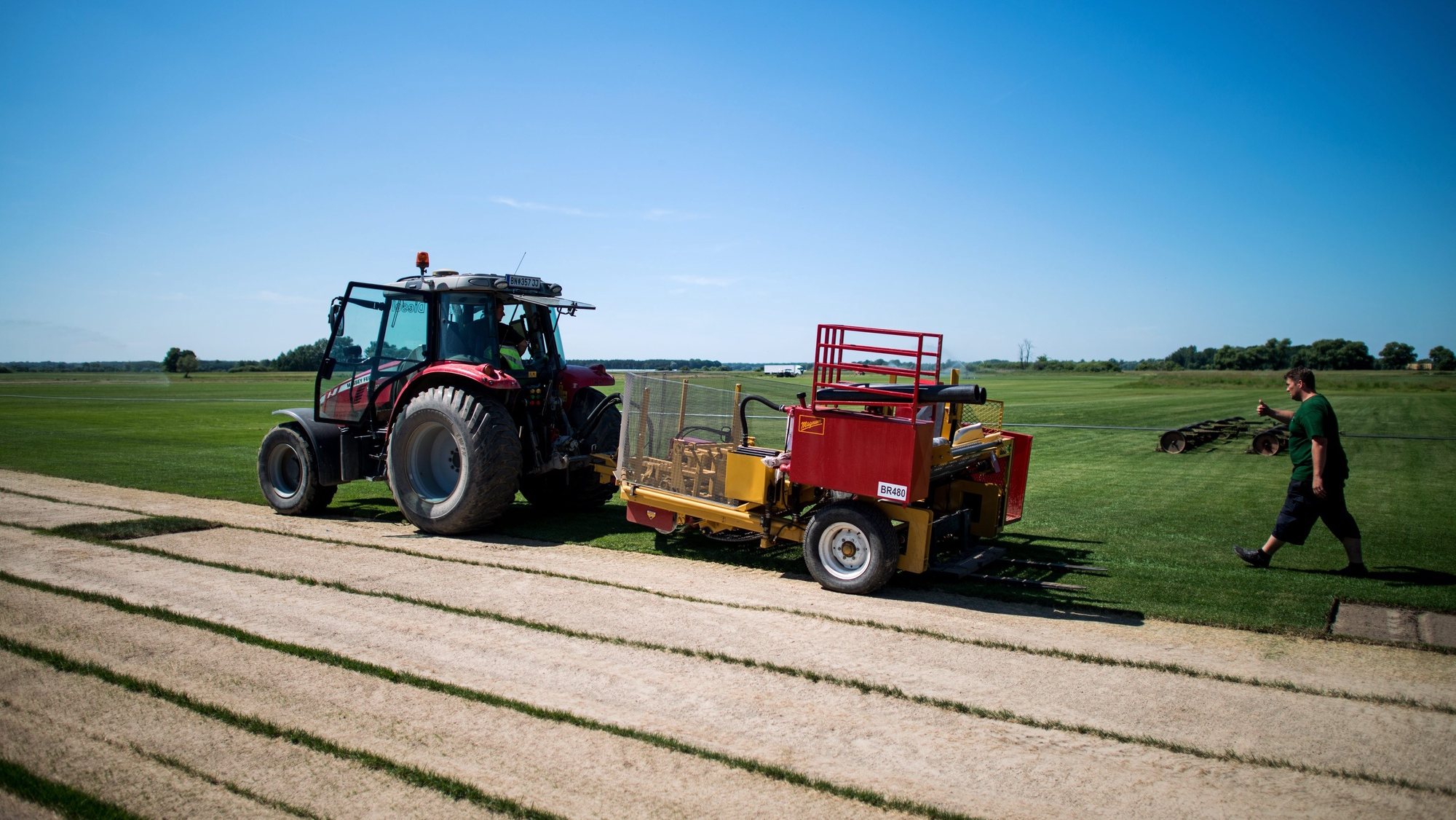 epa05350602 A tractor with a harvester is seen on a sports turf field of turf manufacture Richter Lawn near Zavod, Slovakia, on 07 June 2016. Austrian family business run by the fifth generation, Richter Lawn grows natural turf in Austria and Slovakia. Their special stadium turf lawn, grown on silica sand natural soil, was sodded for the UEFA Champions League Final 2015 in Berlin, Germany, the EURO 2012 in Kiev, Lviv and Donetsk, Ukraine and the EURO 2016 in Nice, Lille and Marseille, France.  EPA/CHRISTIAN BRUNA