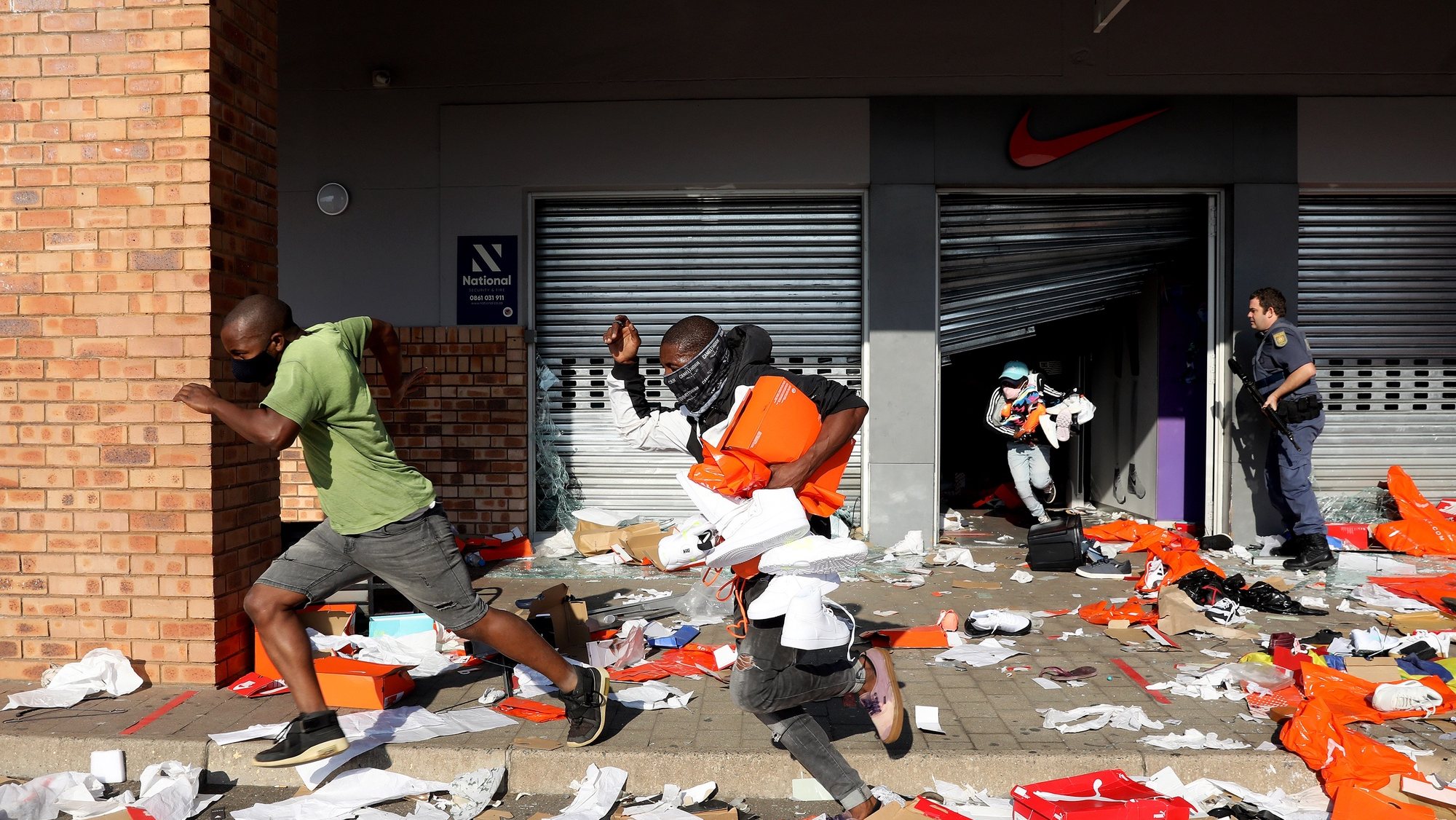 epaselect epa09340528 Looters empty a store of goods in the Springfield Value Centre during protest in, Durban, South Africa, 12 July 2021. Former South Africa President Zuma was arrested on 07 July, and sentenced to 15 months in prison for contempt of court. Protests by his supporters included shops being looted, burned cars and the blocking of city streets in the country.  EPA/STR