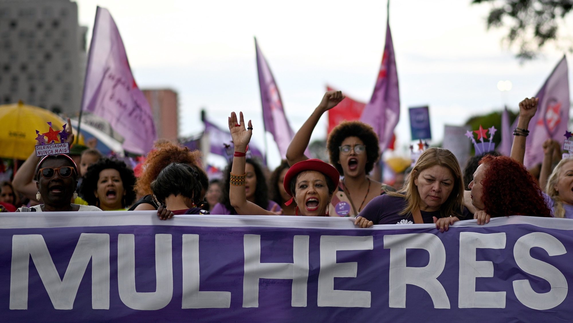 epa10510572 People with a sign reading &#039;women&#039; participate in a demonstration to commemorate International Women&#039;s Day, in Brasilia, Brazil, 08 March 2023. International Women&#039;s Day (IWD) is observed annually on 08 March worldwide to highlight women&#039;s rights, including issues such as violence and abuse against women. The Brazilian President announced on 08 March 20 measures to end wage inequality and combat gender violence.  EPA/Andre Borges