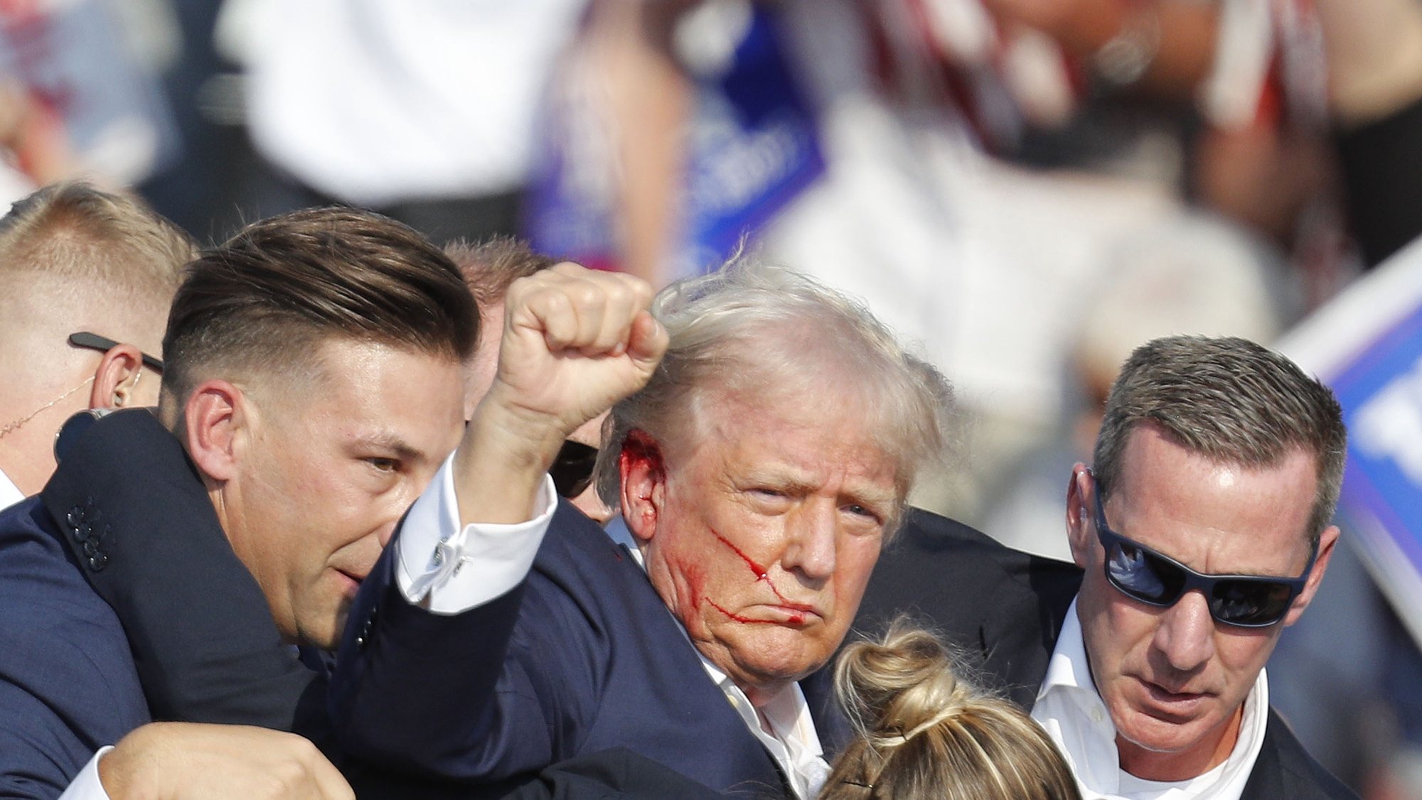 epa11476744 Former US President Donald Trump is rushed off stage by secret service after an incident during a campaign rally at the Butler Farm Show Inc. in Butler, Pennsylvania, USA, 13 July 2024.  EPA/DAVID MAXWELL