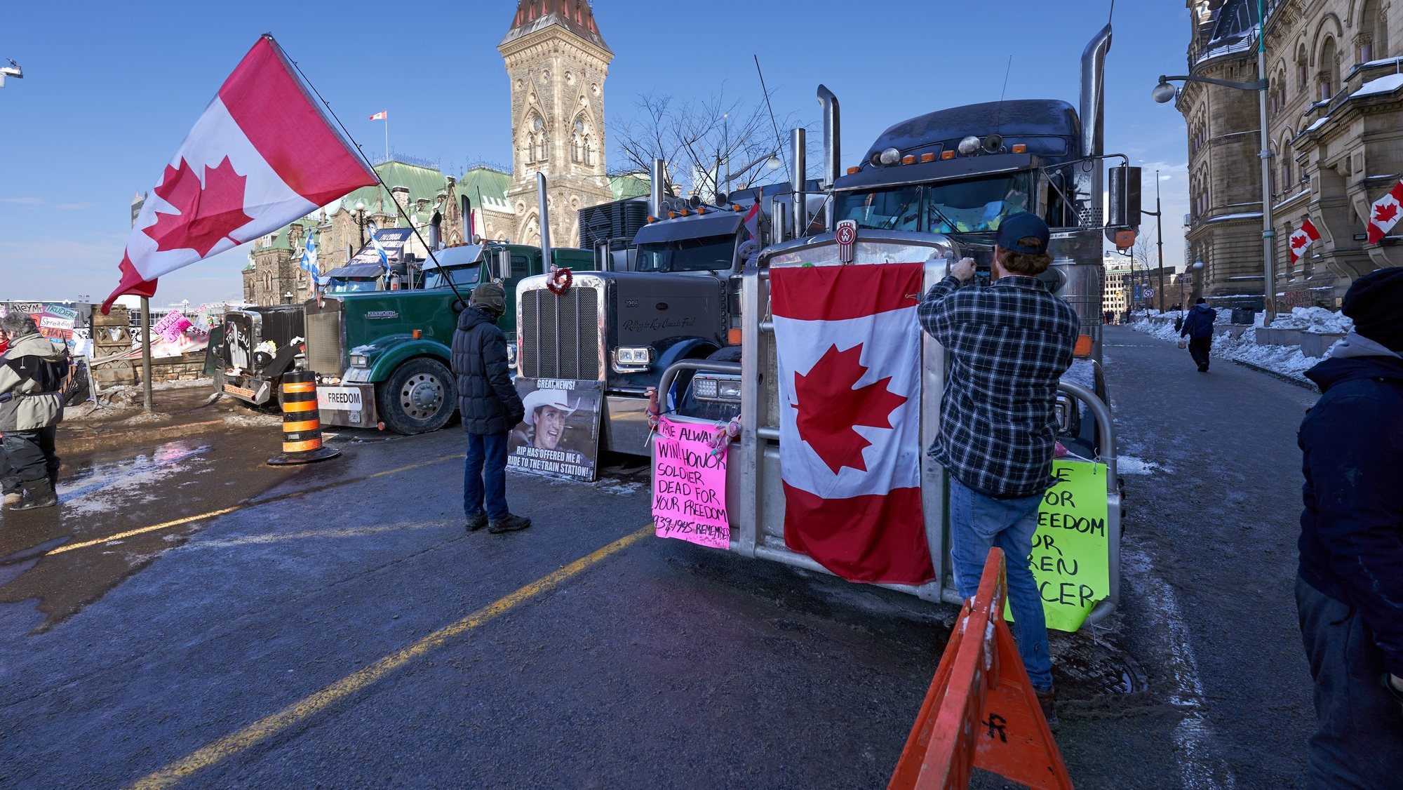 epa09736445 Truckers continue their sit-in near the Canadian parlement hill, after the mayor of Ottawa has declared a state of emergency in the Canadian capital after a 10-day-long protest by truck drivers over Covid-19 restrictions that has gridlocked its city center, in Ottawa, Canada, 07 February 2022. Truckers protested against the mandate by the Canadian government that truckers be vaccinated to return to Canada, and was joined by other opponents of the Canadian Prime Minister. Policemen from Ottawa city, Ontario, and the Federal Royal Canadian Mounted Police (RCMP) are deployed.  EPA/ANDRE PICHETTE