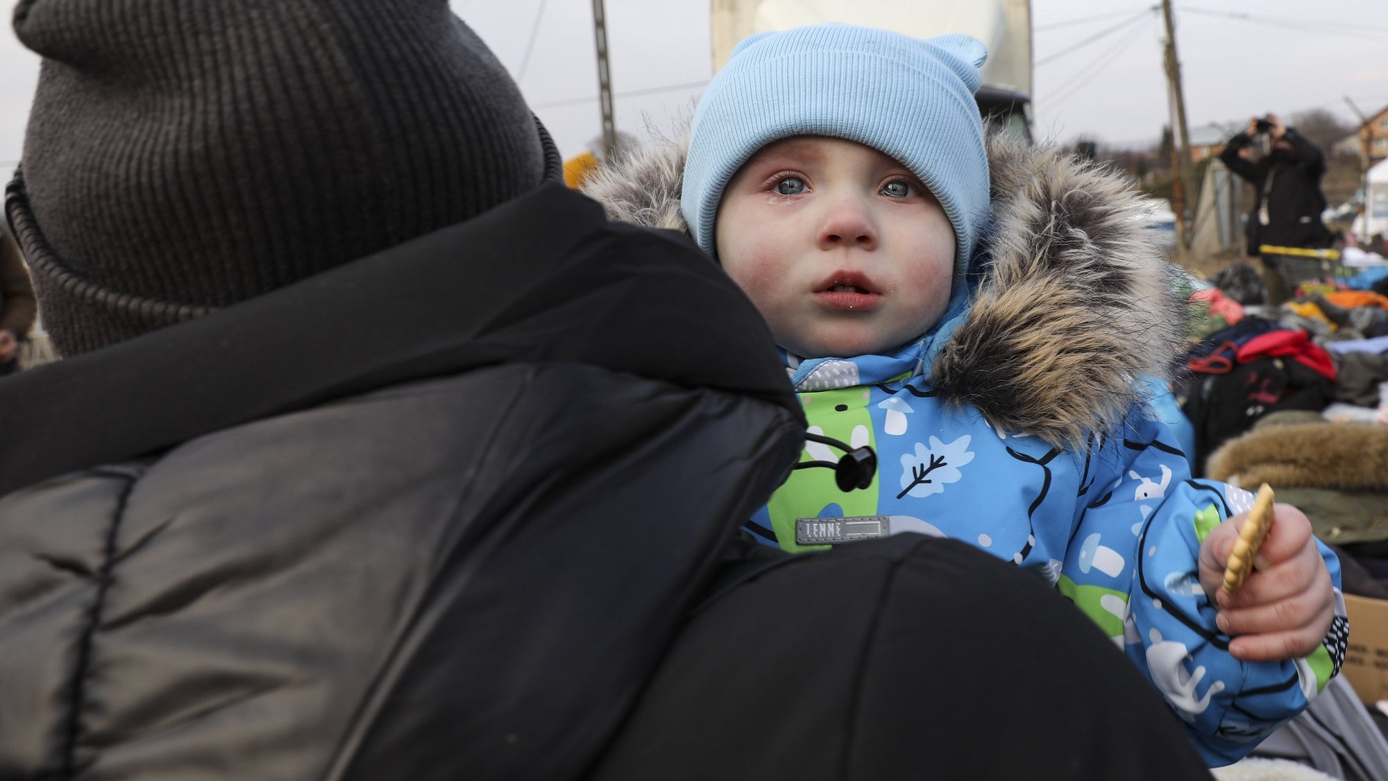 A baby cries near the Shehyni-Medyka border in Medyka, Poland, 03 March 2022. Hundreds of thousands of people have fled from Ukraine into neighboring countries since Russia began its military operation on 24 February MIGUEL A. LOPES/LUSA