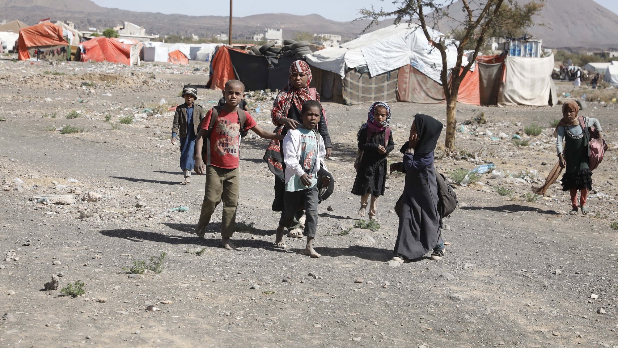 epa09776183 Displaced Yemeni children on their way back from school inside a camp for Internally Displaced Persons (IDPs) on the outskirts of Sana&#039;a, Yemen, 21 February 2022. There is a school inside the camp which is run by Save the Children organization. Save the Children has warned that about 4.3 million children in Yemen will lose all humanitarian aid next March due to donor funding shortages. The international agency estimated that a child dies every ten minutes in war-ridden Yemen from preventable diseases, such as diarrhea and malnutrition since its healthcare system has collapsed and lack of humanitarian needs, including nutrition, clean water and safe sanitation, due to seven years of escalating conflict.  EPA/YAHYA ARHAB