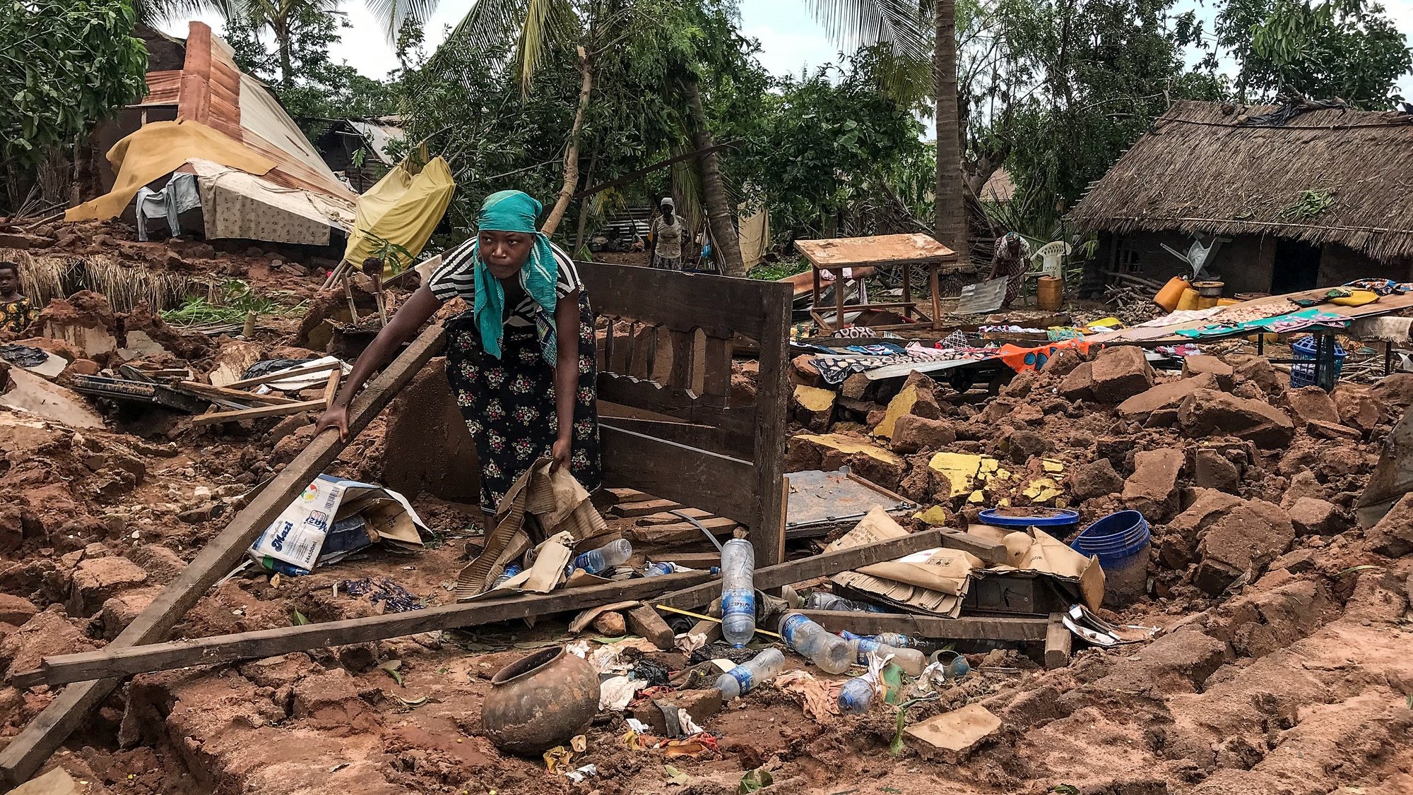 epa09822032 A local woman inspects the damages to the houses destroyed by Cyclone Gombe, Topelane neighborhood, Monapo village, Nampula province, Mozambique, 13 March 2022. Storm Gombe reached the Mozambican coast in the early hours of 11 March morning in the category of an intense cyclone with torrential rain and wind of 165 kilometers per hour, with gusts exceeding 200 km/hour.  EPA/ANDRE CATUEIRA