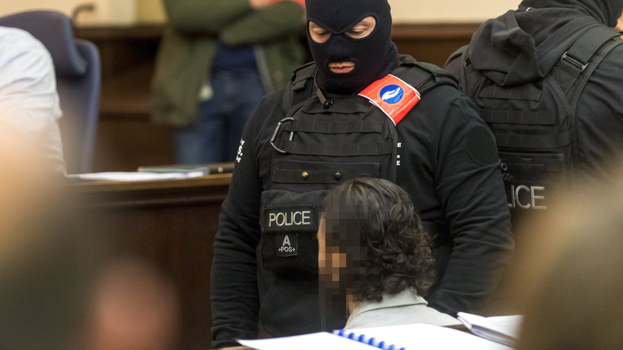 epa06497778 Prime suspect in the November 2015 Paris attacks Salah Abdeslam (R) sits as he is surrounded by Belgian special police officers  in the courtroom prior to the opening of the trial of terror suspects Salah Abdeslam and Sofiane Ayari, also known as Amine Choukri, in Brussels, Belgium, 05 February 2018. Terrorist suspects Salah Abdeslam and Sofiane Ayari are on trial for attempted murder of police searching for suspects of the November 2015 Paris terror attacks that left 130 people dead, when Abdeslam was on the run and hiding in the Belgian capital. Abdeslam allegedly escaped a shootout with Belgian police in March 2016 during which he wounded four officers but was captured and arrested some days later in downtown Brussels. The trial in Belgium only deals with the shootout prior to the arrest. His role in the Paris terrorist attacks will be tried in a court in France at a later stage.  EPA/DANNY GYS / POOL
