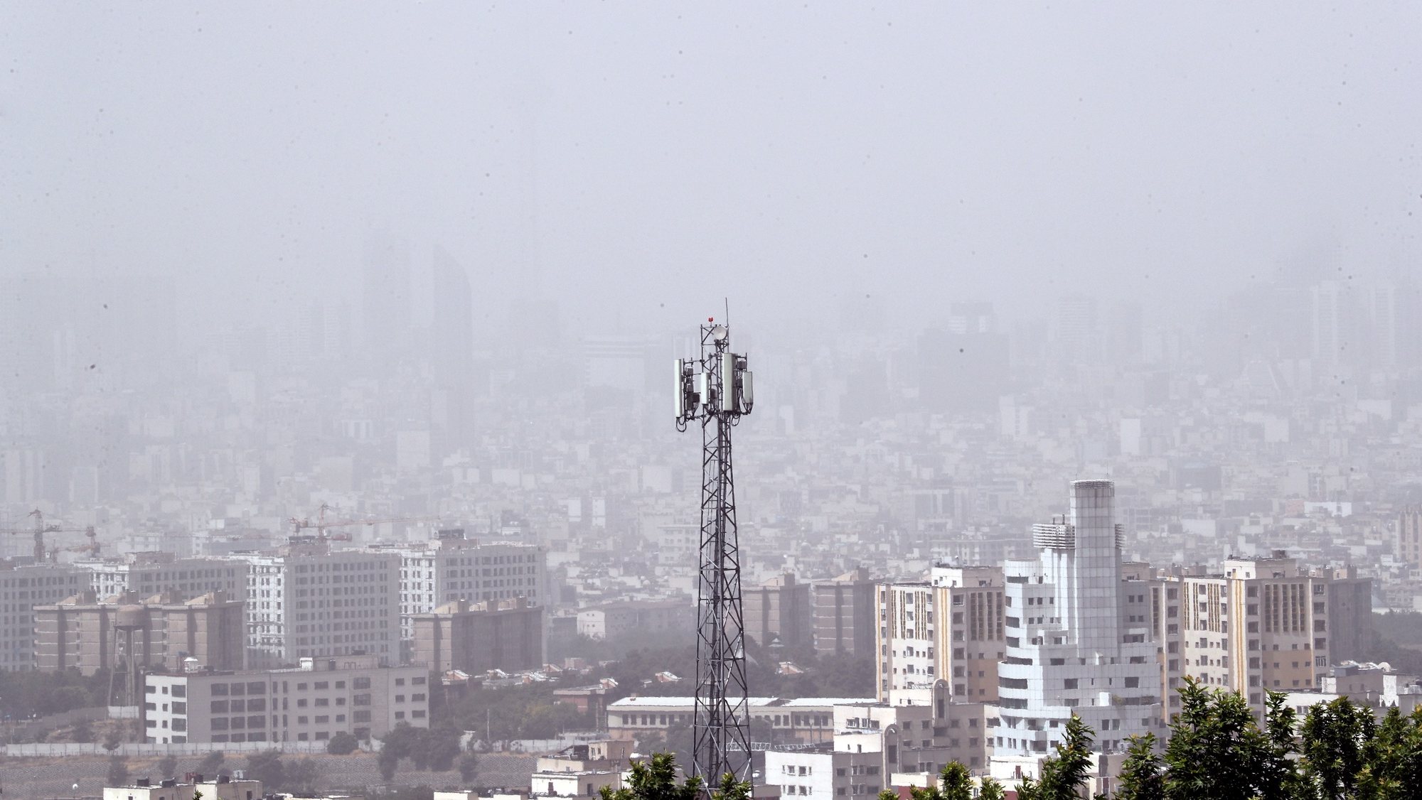 epa09973895 Dust engulfs the skyline in Tehran, Iran, 25 May 2022. The Iranian government announced a one-day public holiday during which all schools, universities and government departments will be closed due to heavy dust and air pollution which reached dangerous levels. The government insists that elderly and sick people should stay indoors.  EPA/ABEDIN TAHERKENAREH