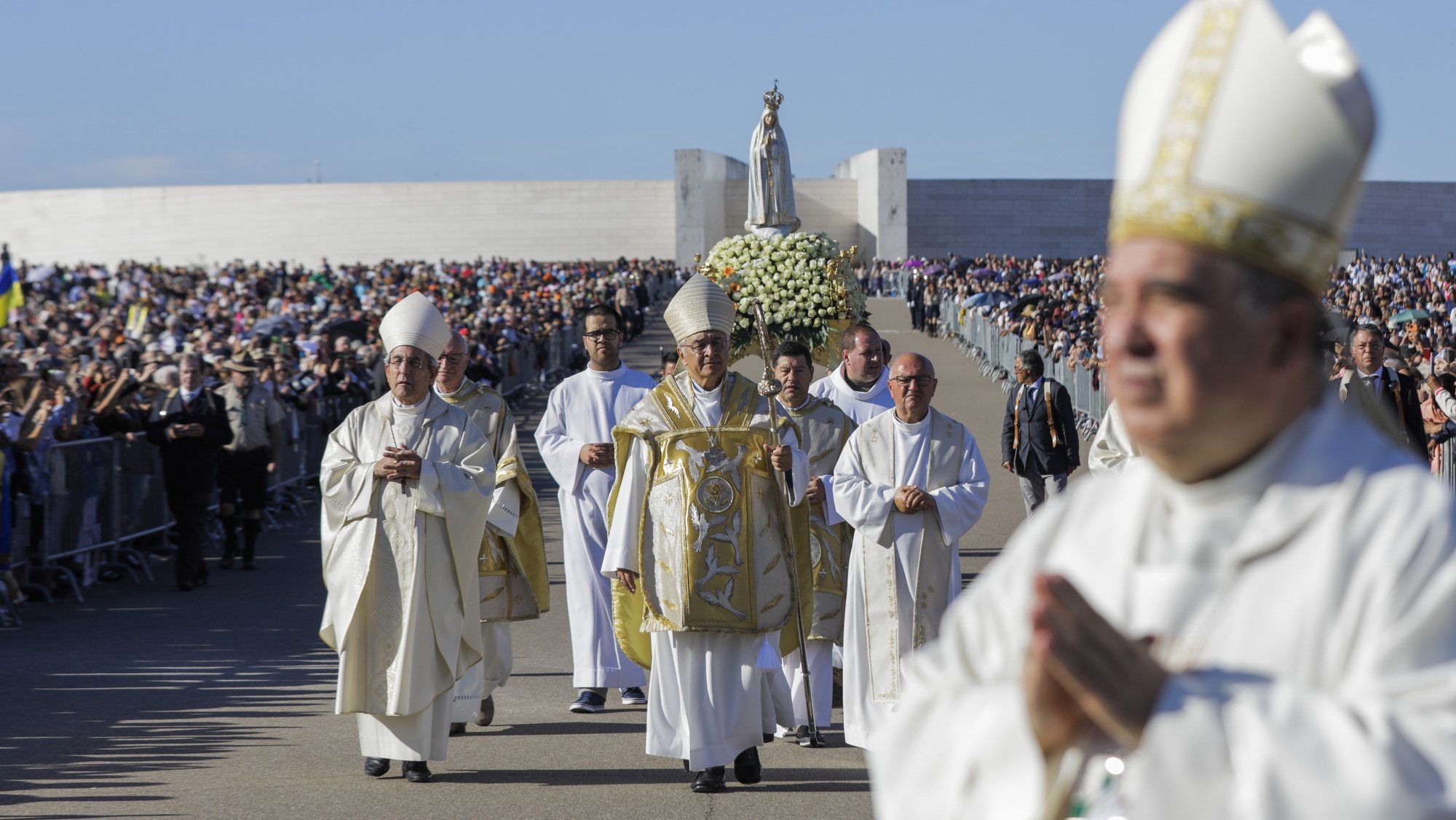 The bishop of Leiria and Fatima Dom Jose Ornelas (C) accompany the statue of Our Lady of Fatima is carried on a litter during the annual international pilgrimage on 12 and 13 October in the Shrine of Fatima, Portugal, 13 October 2022. PAULO CUNHA/LUSA