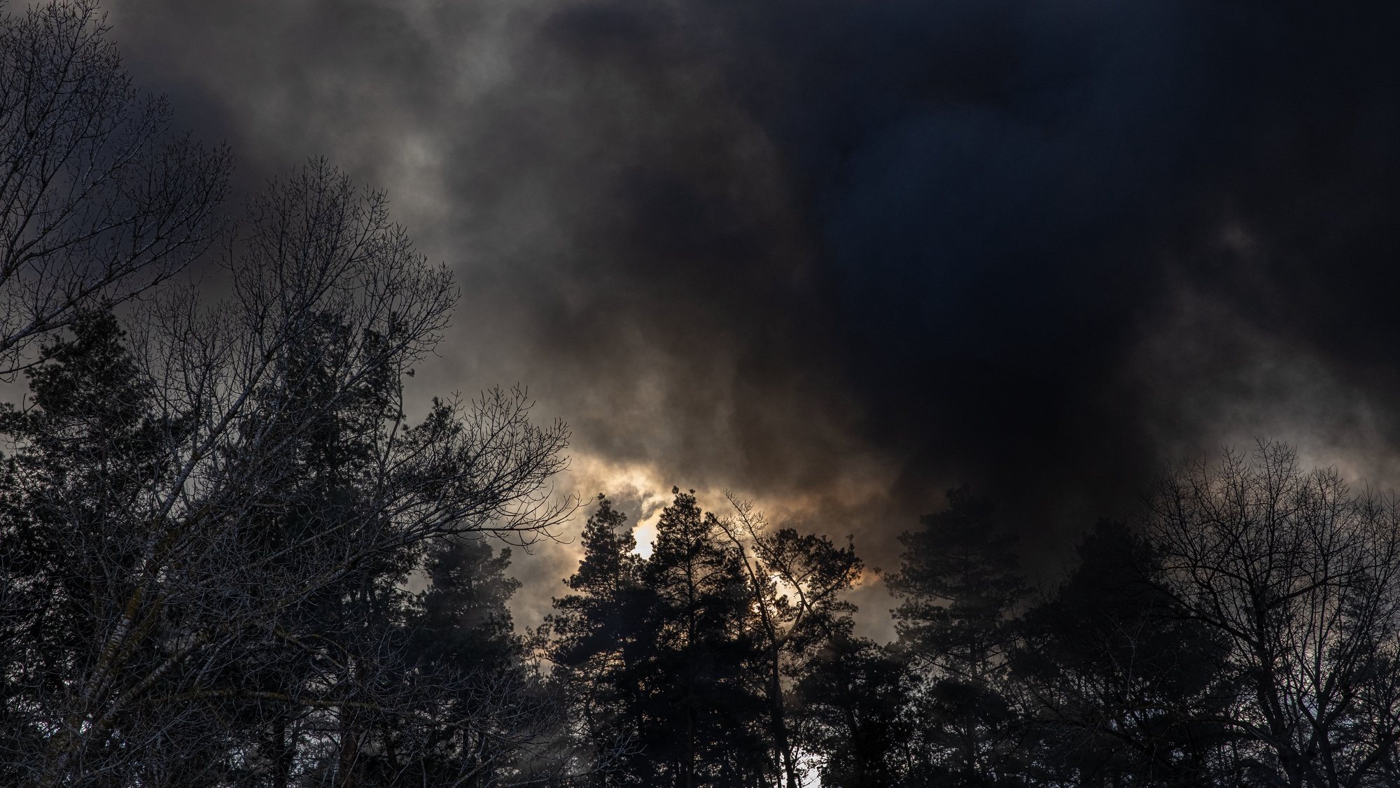 epa09810688 Smoke comes from the warehouse after falling down of a Russian Kalibr missile debris which was shot down over Kalynivka village, near Brovary, the eastern frontline of Kyiv (Kiev) region, Ukraine, 08 March 2022. According to the United Nations High Commissioner for Refugees (UNHCR), Russia&#039;s military invasion of Ukraine, which started on 24 February, has destroyed civilian infrastructure and caused civilian casualties, with tens of thousands internally displaced and over two million refugees fleeing the country.  EPA/ROMAN PILIPEY