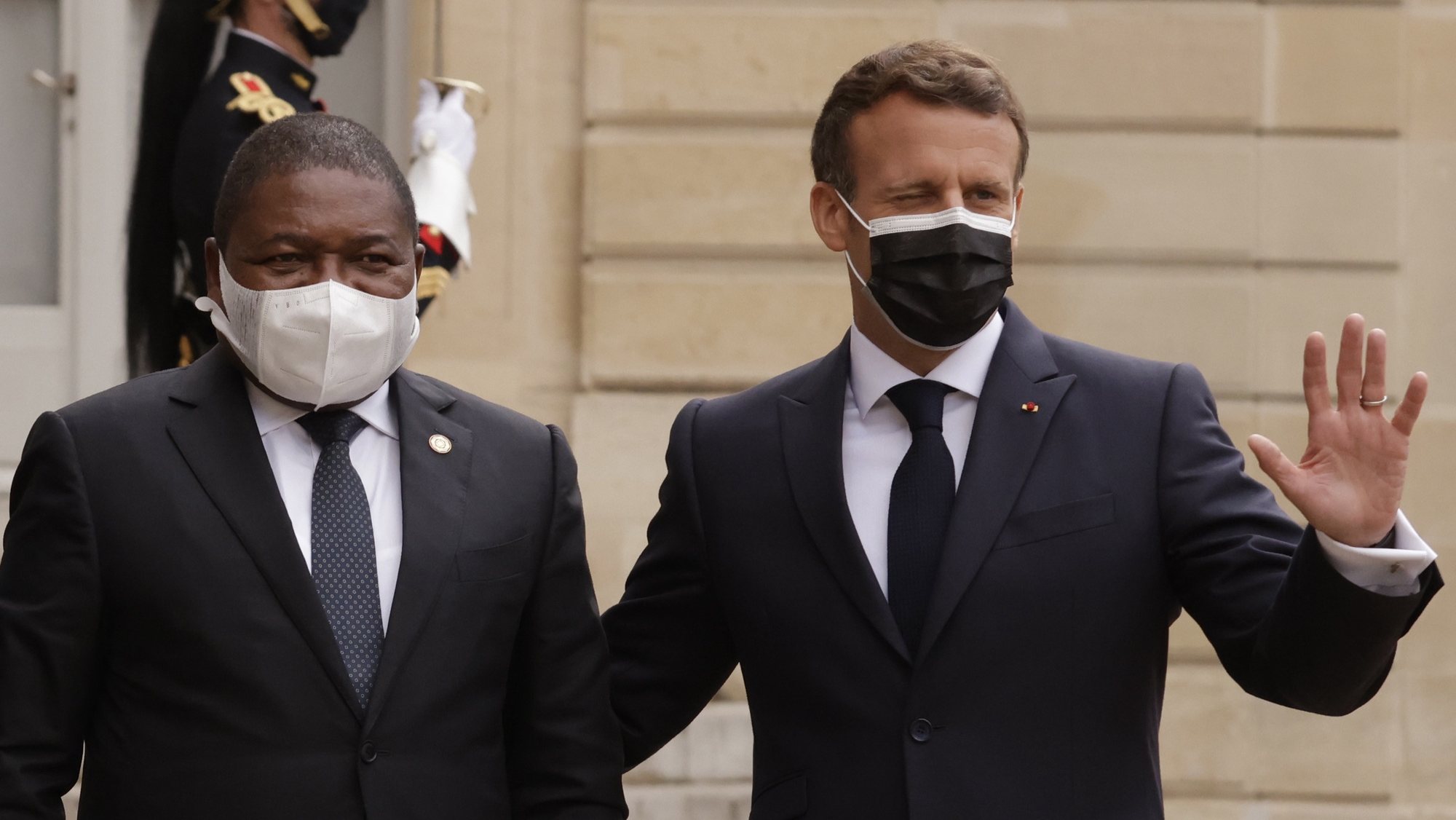 epa09207492 French President Emmanuel Macron (R) welcomes Mozambique&#039;s President Filipe Nyusi (L), before a dinner at the Elysee Palace folowing a summit on the African Economy financing in Paris, France, 17 May 2021.  EPA/YOAN VALAT
