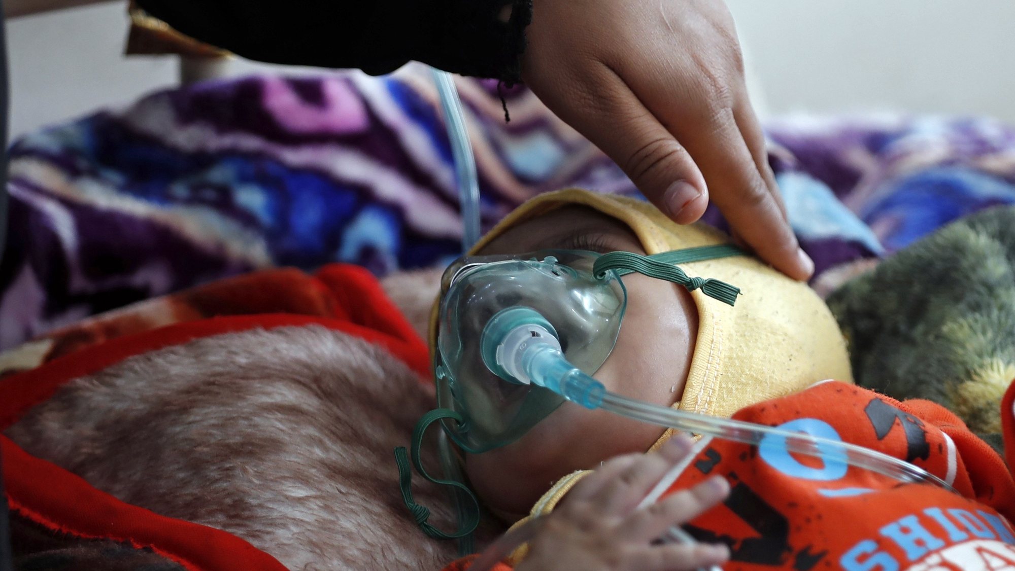 epa08033744 A woman takes care of her patient child receiving treatment at a hospital, Sanaa, Yemen, 19 November 2019 (issued 29 November 2019). According to reports, at least 12 million children in war-ridden Yemen need urgent humanitarian aid as a new wave of epidemic diseases, including dengue fever and malaria, have been spreading rapidly across the Arab country since the beginning of the escalating conflict in 2015.  EPA/YAHYA ARHAB