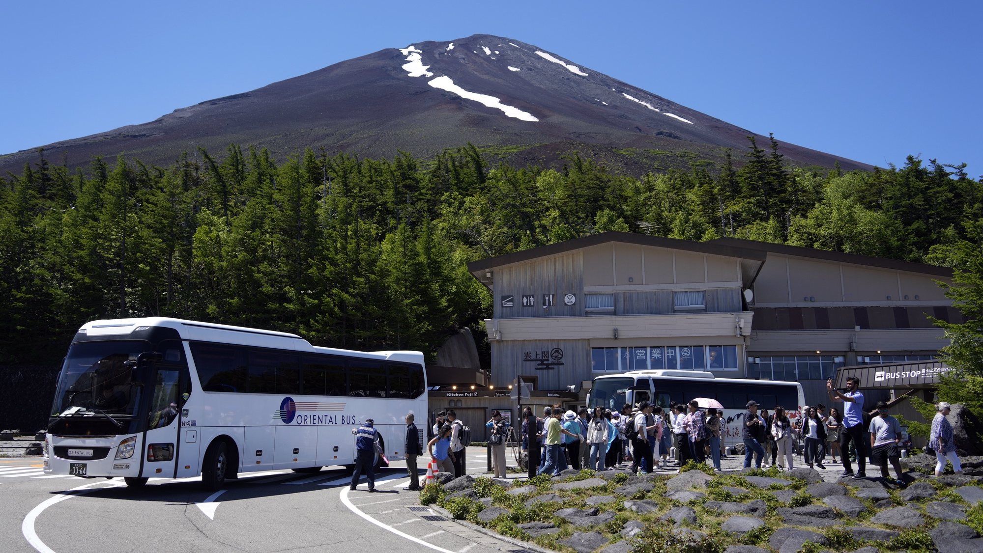 epa11421883 Tourists gather at Mount Fuji 5th station in Yamanashi prefecture, Japan, 19 June 2024. For the first time, the prefecture will start collecting a mandatory hiking fee of 2000 yen (about 12 euros) per person and an optional &#039;donation fee&#039; of 1000 yen (6 euros) per person for climbing the Mount Fuji from the 5th station. An online reservation system started operations on 20 May 2024 ahead of the opening of the Mt. Fuji Yoshida Route on 01 July 2024. Also, access to the Yoshida Route will be limited to 4000 people per day during the hiking season from 01 July until 10 September 2024. According to data released by Japan National Tourism Organization on 19 June 2024, the number of foreign visitors traveling to Japan topped the three million mark for the third month in a row, an increase of 60 percent from the same month of 2023.  EPA/FRANCK ROBICHON