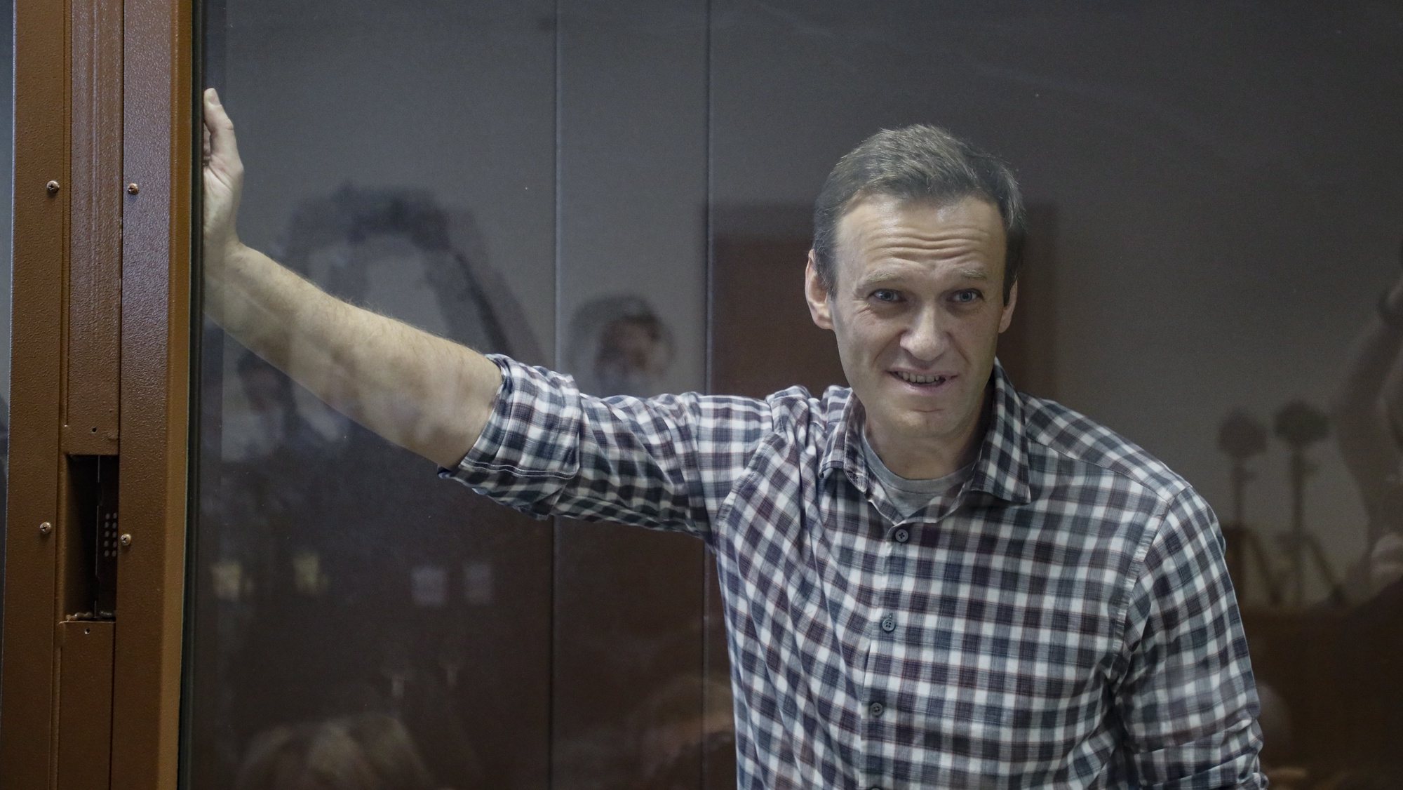 epa09025238 Russian opposition leader Alexei Navalny stands inside a glass cage prior to a hearing at the Babushkinsky District Court in Moscow, Russia, 20 February 2021. The Moscow City court will hold a visiting session at the Babushkinsky District Court Building to consider Navalny&#039;s lawyers appeal against a court verdict issued on 02 February 2021, to replace the suspended sentence issued to Navalny in the Yves Rocher embezzlement case with an actual term in a penal colony.  EPA/YURI KOCHETKOV MANDATORY CREDIT