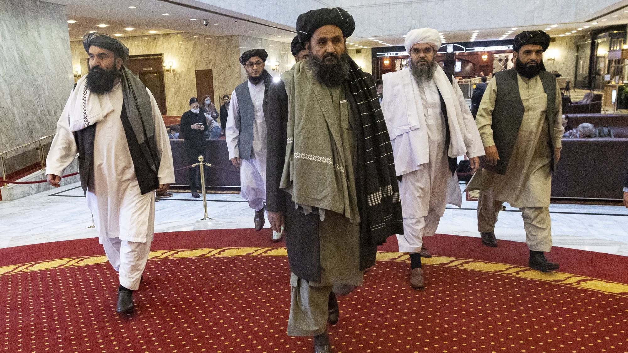 epa09082252 Taliban co-founder Mullah Abdul Ghani Baradar (C) arrives with other members of the Taliban delegation for attending an international peace conference in Moscow, Russia, 18 March 2021. Russia is hosting a peace conference for Afghanistan, bringing together government representatives and their Taliban adversaries along with regional observers in a bid to help jump-start the country&#039;s stalled peace process. The one-day gathering Thursday is the first of three planned international conferences ahead of a May 1 deadline for the final withdrawal of U.S. and NATO troops from the country, a date fixed under a year-old agreement between the Trump administration and the Taliban.  EPA/ALEXANDER ZEMLIANICHENKO / POOL