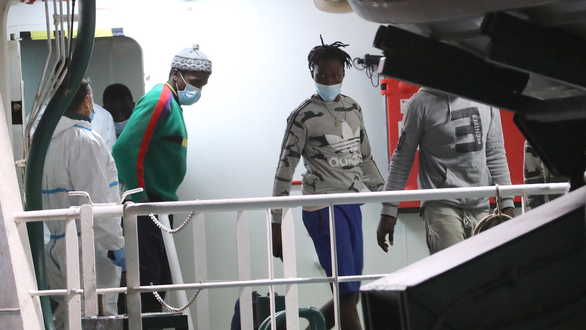 epa09551606 Some of the 30 rescued migrants disembark from the Guardia Civil&#039;s &#039;Rio Segura&#039; Ship in Las Palmas de Gran Canaria, Canary Islands, Spain, late 28 October 2021 (issued 29 October 2021). A total of 30 migrants were found some 200 miles south from the island.  EPA/ELVIRA URQUIJO A.