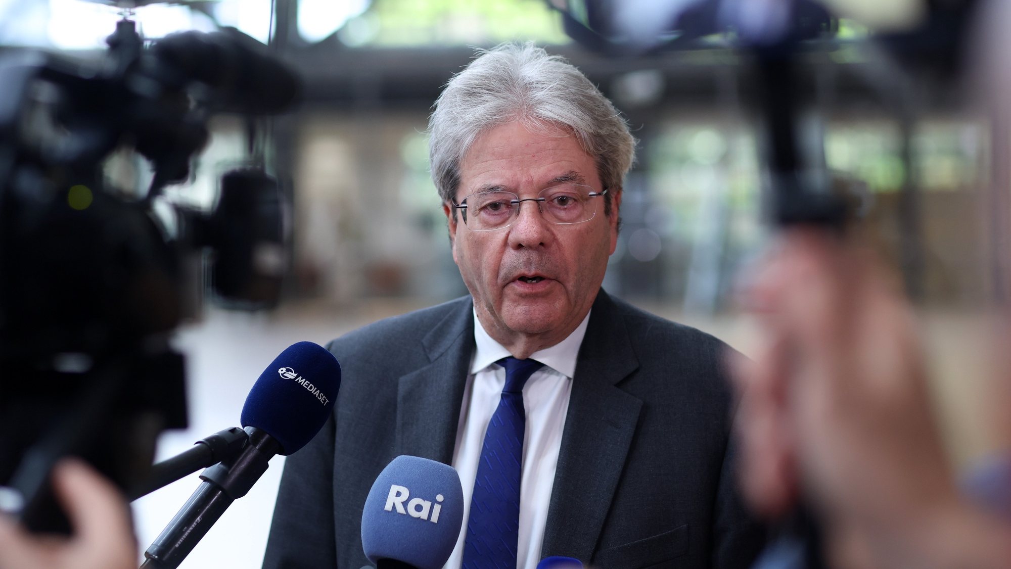 epa11336842 European Commissioner in charge of Economy, Paolo Gentiloni, speaks to the press at the start of a Eurogroup finance ministers meeting in Brussels, Belgium, 13 May 2024. The meeting will include an assessment of the latest macroeconomic developments and outlook, including a briefing on recent international meetings. The Commission is also expected to share its views on recent budgetary developments in the euro area.  EPA/OLIVIER HOSLET
