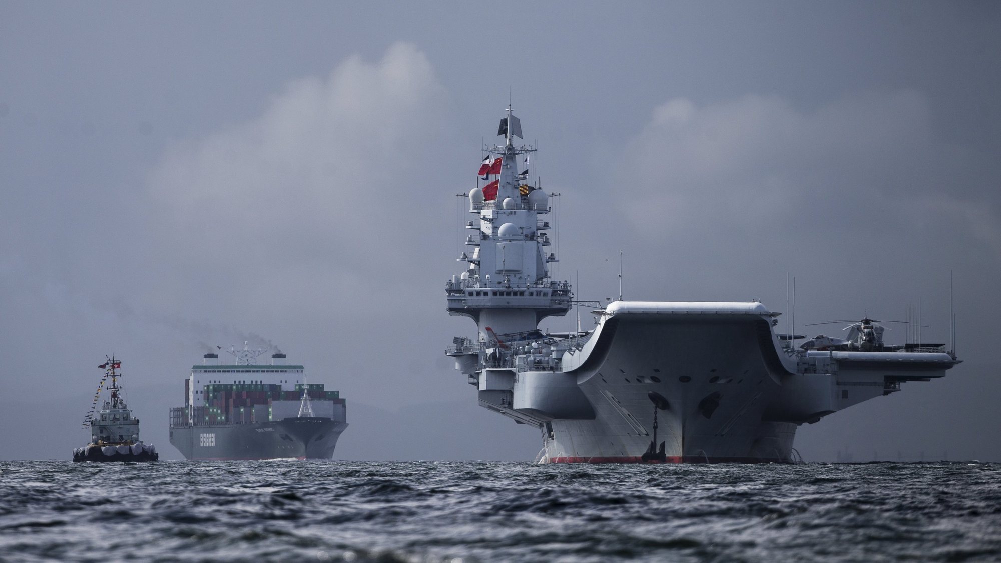 epaselect epa06071725 The Liaoning (R), the first aircraft carrier commissioned into China&#039;s military, arrives in Hong Kong, China, 07 July 2017. The Liaoning, a refitted former Soviet carrier that Beijing bought from a Ukraine shipyard in 1998, is making a 5-days port call to Hong Kong as part of the 20th anniversary celebrations of Hong Kong&#039;s return to Chinese sovereignty.  EPA/JEROME FAVRE