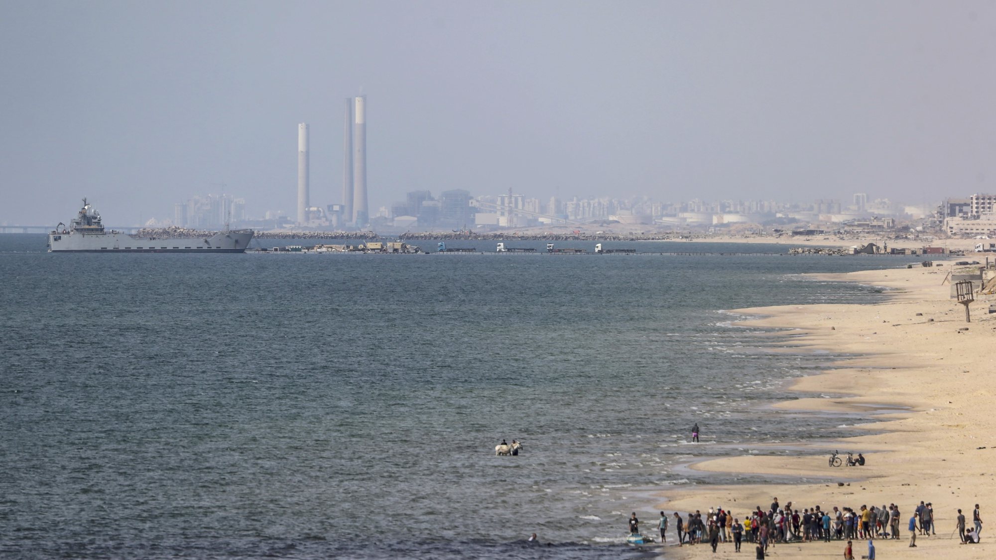 epa11353661 A ship is seen from southern Gaza, moored near a temporary floating pier anchored by the United States to boost aid deliveries, Gaza, 19 May 2024. Since 07 October 2023, up to 1.7 million people, or more than 75 percent of the population, have been displaced throughout the Gaza Strip, some more than once, in search of safety, according to the United Nations Relief and Works Agency for Palestine Refugees in the Near East (UNRWA), which added that the Palestinian enclave is &#039;on the brink of famine&#039;, with 1.1 million people (half of its population) &#039;experiencing catastrophic food insecurity&#039; due to the conflict and restrictions on humanitarian access.  EPA/MOHAMMED SABER