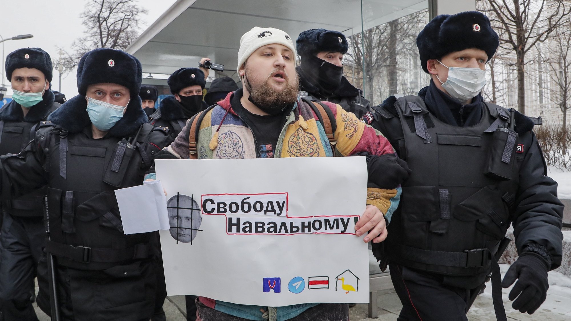 epa08959290 Police officers remove a protester holding a poster showing Russian President Vladimir Putin and reading &#039;Freedom for Navalny&#039; during an unauthorized protest in support of Russian opposition leader and blogger Alexei Navalny, in Moscow, Russia, 23 January 2021. Navalny was detained after his arrival to Moscow from Germany on 17 January 2021. A Moscow judge on 18 January ruled that he will remain in custody for 30 days following his airport arrest. Navalny urged Russians to take to the streets to protest. In many Russian cities mass events are prohibited due to an increasing number of cases of the COVID-19 pandemic caused by the SARS CoV-2 coronavirus.  EPA/MAXIM SHIPENKOV