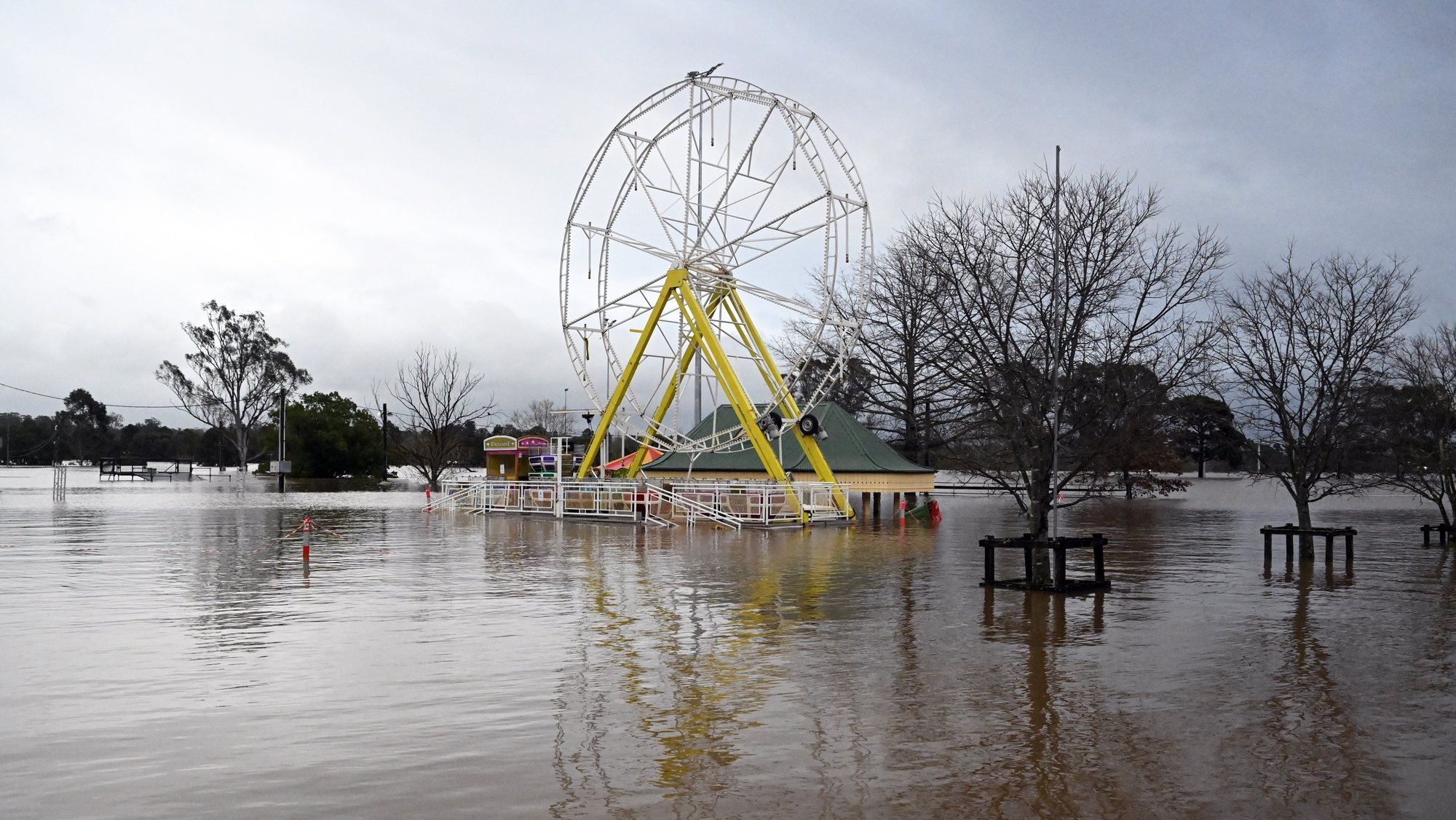 epaselect epa10049202 An amusement ride is seen inundated by floodwaters in Camden in South Western Sydney, Australia, 03 July 2022. Torrential rain and damaging winds hit New South Wales state forcing the evacuation of thousands of residents. New South Wales emergency services minister Steph Cooke warned citizens that the floods could be more dangerous than last year&#039;s.  EPA/MICK TSIKAS  AUSTRALIA AND NEW ZEALAND OUT