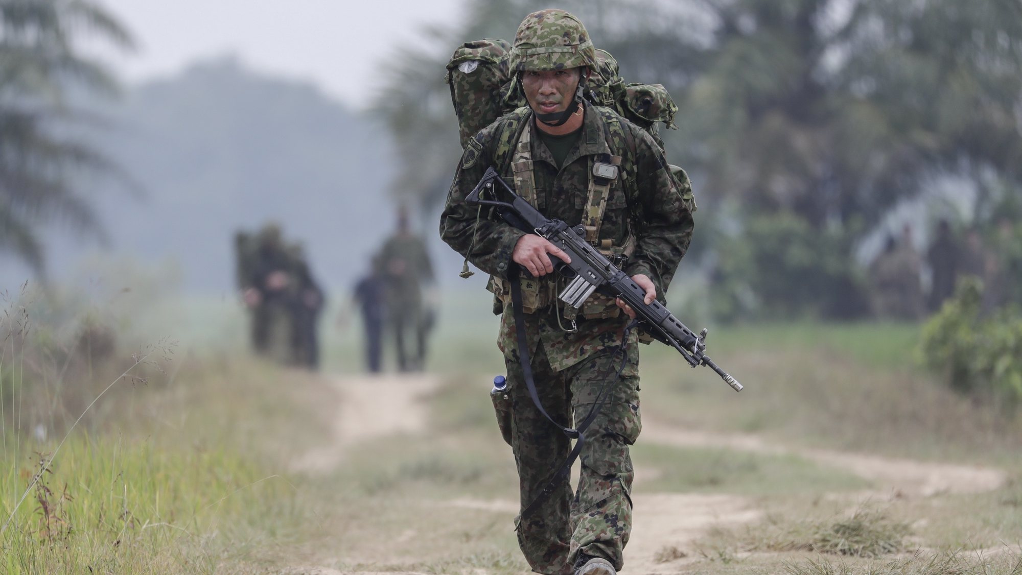 epa10103646 A member of Japan Ground Self-Defense Force carries his rifle during the Super Garuda Shield joint military drill in Baturaja, South Sumatra, Indonesia, 03 August 2022. Indonesia, US, Australia, Japan and Singapore staged a joint military drill to tighten military relationships between the countries amid the rising tensions in the region, following the visit of the US House Speaker Nancy Pelosi to Taiwan.  EPA/MAST IRHAM
