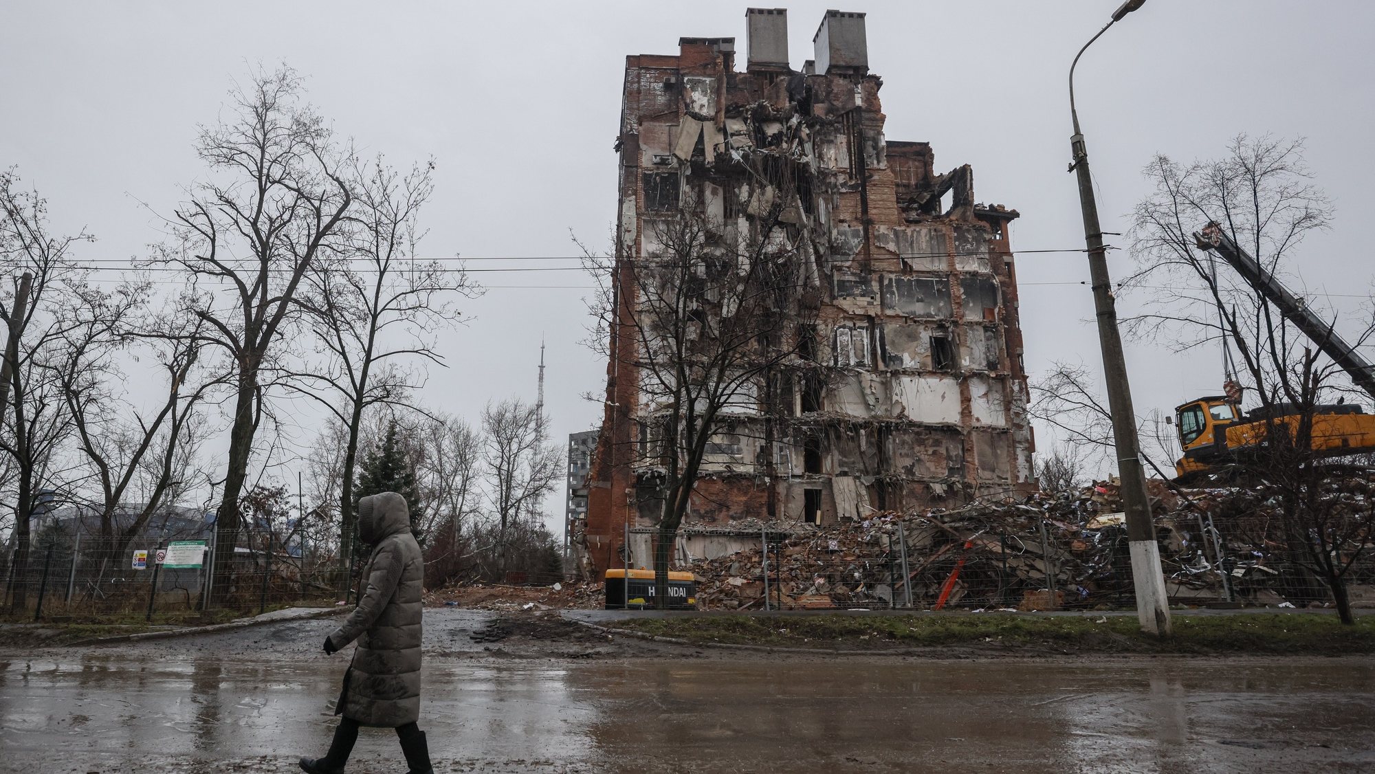 epa10362476 A local man walks in front of a destroyed building in downtown Mariupol, Ukraine, 12 December 2022. Mariupol had seen a long battle for its control between the Ukrainian forces and the Russian army and Russian backed separatist Donetsk Peopleâ€™s Republic (DPR) as well as a siege, the hostilities lasted from February to the end of May 2022 killing thousands of people and destroying most of the city in the process. According to the DPR government which took control after May 2022, more than five thousand builders are currently working in Mariupol, they expect the city to be completely rebuilt in three years&#039; time.  EPA/SERGEI ILNITSKY