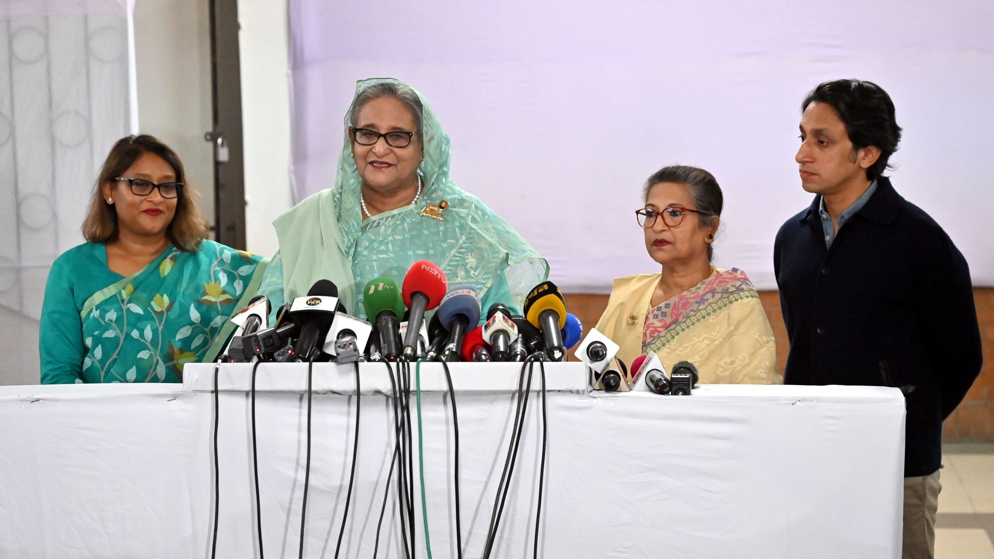 epa11062520 A handout photo made available by the Bangladesh prime minister&#039;s office shows Bangladesh Prime Minister and Awami League President Sheikh Hasina (C) talking to the media after casting her vote at the Dhaka City College polling center during the 12th national general election in Dhaka, Bangladesh, 07 January 2024. The last general election in Bangladesh was held in 2018. People are voting to select members of the national parliament, also known as Jatiya Sangsad.  EPA/BANGLADESH PRIME MINISTER&#039;S OFFICE / HANDOUT  HANDOUT EDITORIAL USE ONLY/NO SALES HANDOUT EDITORIAL USE ONLY/NO SALES