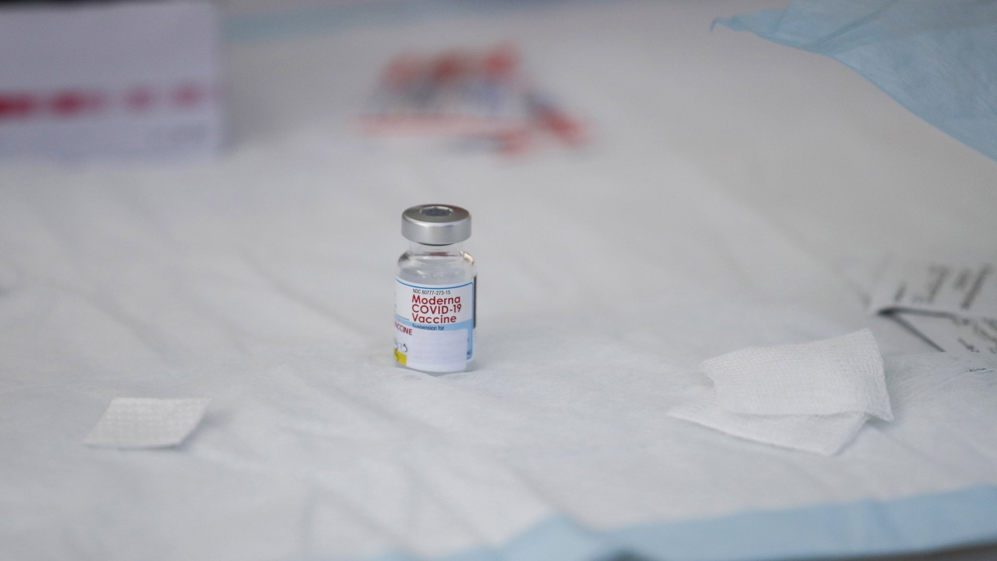 epa09482475 A vial containing Moderna Covid-19 vaccine sits on a table at a clinic for individuals experiencing homelessness at San Julian Park in Los Angeles, California, USA, 22 September 2021.  EPA/CAROLINE BREHMAN