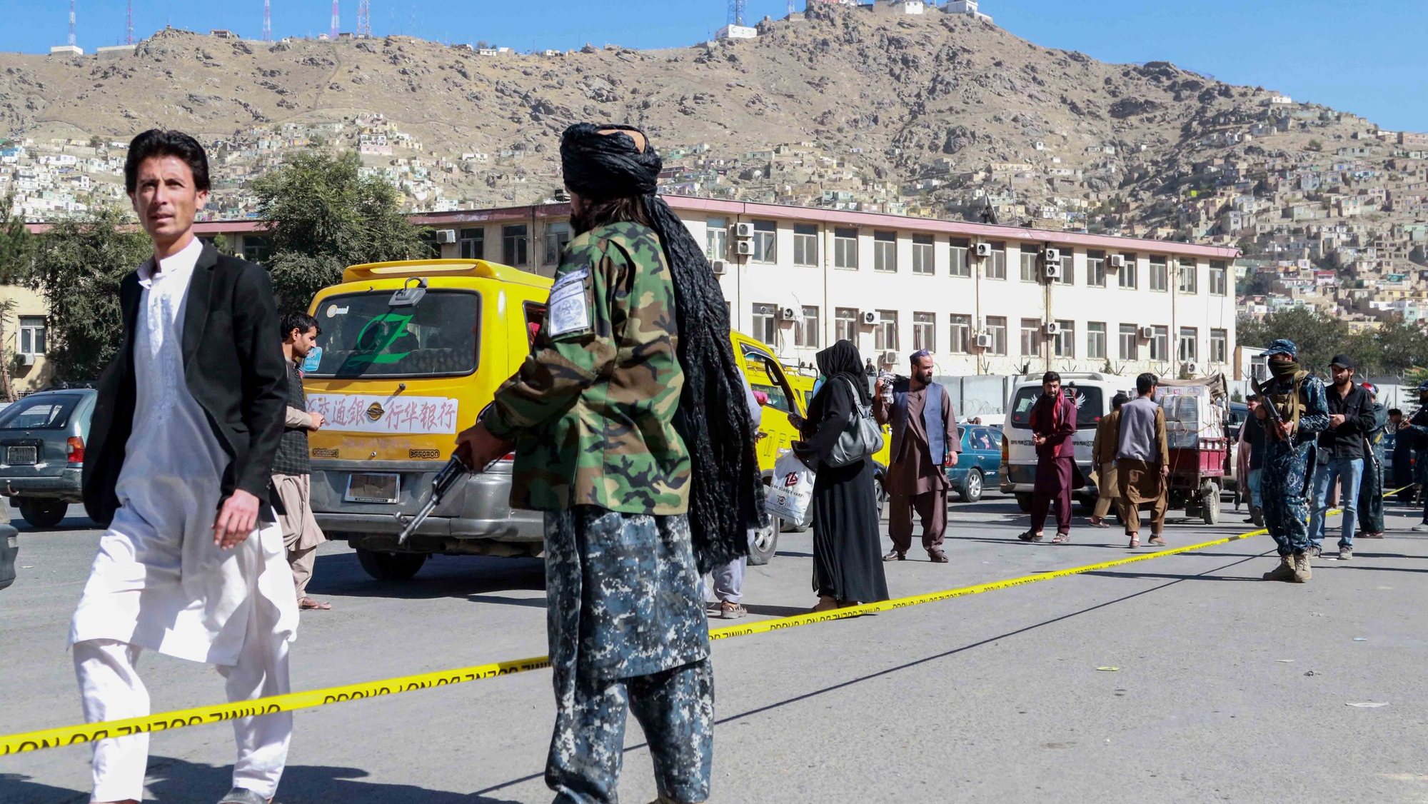 epa09534068 Taliban stand guard at the scene of a bomb blast in Kabul, Afghanistan, 20 October 2021. At least two people were killed according to the Afghan Interior Ministry in a blast that earlier rocked the Deh Mazang district in Kabul.  EPA/STRINGER