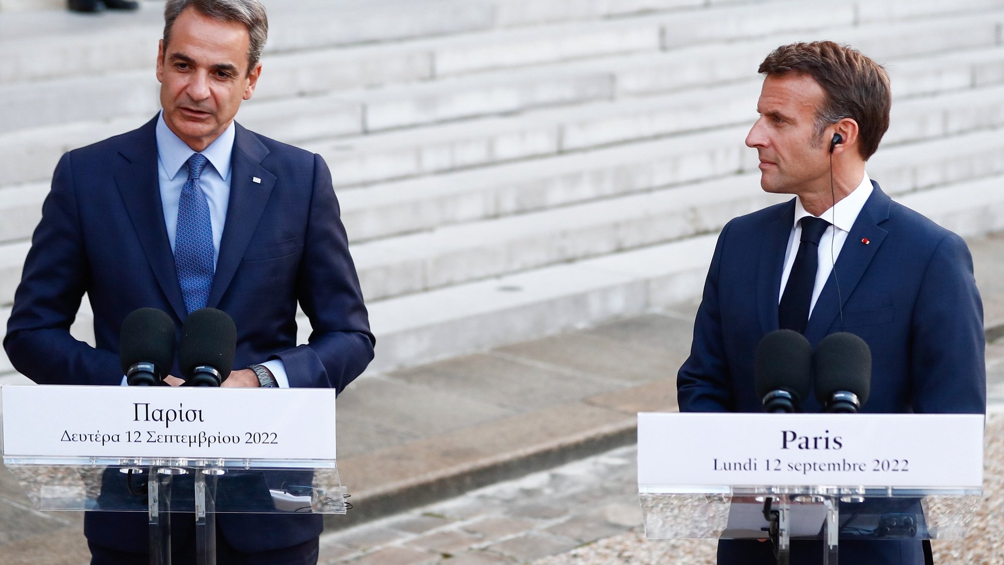 epa10180302 Greek Prime Minister Kyriakos Mitsotakis (L) and French president Emmanuel Macron (R), attend a press conference before their meeting at the Elysee Palace in Paris, France, 12 September 2022.  EPA/Mohammed Badra