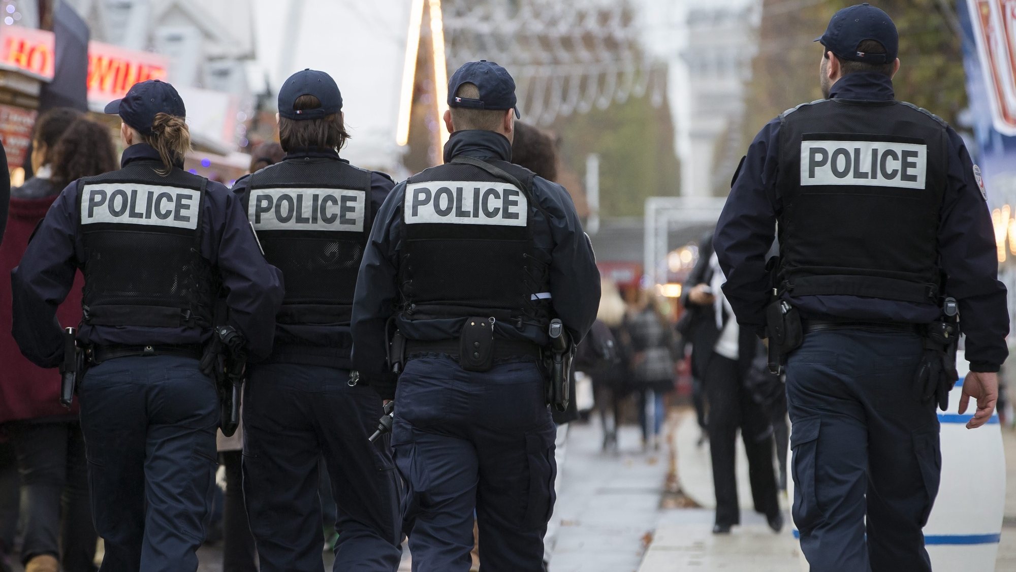 epa05033098 French police officers patrol the outdoor Christmas market on the renowned Avenue des Champs-Elysees in Paris, as part of the state-of-emergency and heightened security measures in Paris following the 13 November attacks, in Paris, France, 19 November 2015. Paris suffered terrorist attacks at the hands of the so-called Islamic State on November 13, when Islamist suicide bombers and gunmen claimed the lives of 129 people, and injured 352.  EPA/IAN LANGSDON