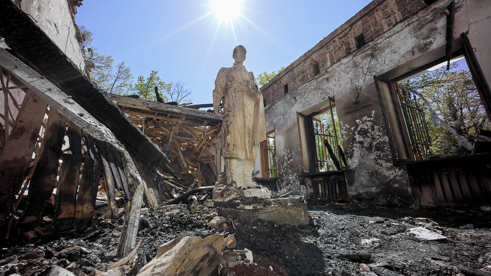 epaselect epa09931872 A view of the statue of Ukrainian philosopher Hryhoriy Skovoroda standing in the damaged Hryhoriy Skovoroda Literary Memorial Museum after shelling in Skovorodynivka village near Kharkiv, Ukraine, 07 May 2022. Skovoroda, a famous philosopher and poet of the 18th century, spent the last years of his life in the estate of local landlords in the village of Ivanovka, which was later renamed in his honor, Skovorodynivka. Russian troops entered Ukraine on 24 February, resulting in fighting and destruction in the country and fears of shortages in energy and food products globally. According to data released by the United Nations High Commission for the Refugees (UNHCR) on 06 May, over 5.8 million refugees have fled Ukraine seeking safety, protection and assistance in neighboring countries, making this the fastest growing refugee crisis since World War II. Western countries have responded with various sets of sanctions against Russian state majority owned companies and interests in a bid to bring an end to the conflict.  EPA/SERGEY KOZLOV