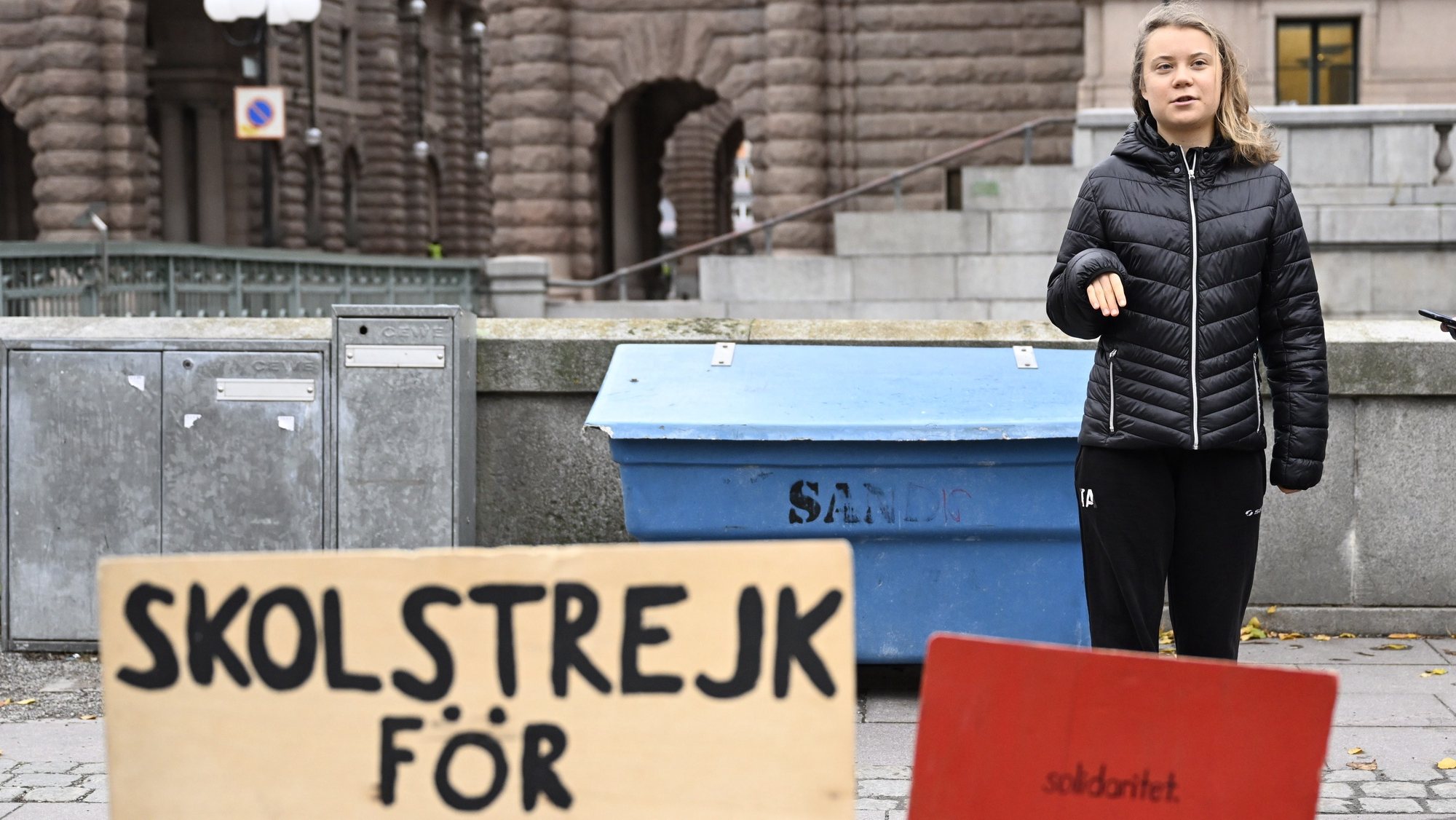 epa10299301 wedish climate activist Greta Thunberg stands next to a placard (L) reading &#039;school strike for climate&#039; during the weekly Fridays for Future demonstration, at Mynttorget square near the Swedish Parliament in Stockholm, Sweden, 11 November 2022.  EPA/PONTUS LUNDAH  SWEDEN OUT