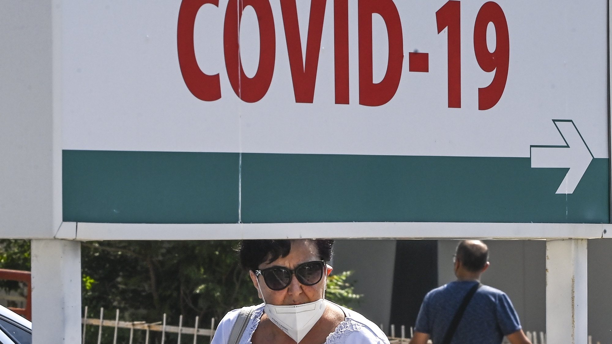 epa09417747 A woman wearing protective mask, walks in front of the University Clinic for Infectious Diseases in Skopje, North Macedonia, 17 August 2021. The number of new coronavirus cases has grow at an alarming rate in North Macedonia over the past two weeks.The situation with the COVID-19 has drastically worsened. Capacities of infectious diseases clinics have been filled. North Macedonia’s Government start with implementation of anti-COVID-19 measures for those who did not get a vaccine. Citizens who have not received the vaccine against COVID-19 cannot enter cafeterias, restaurants and all public enclosed spaces. The penalty for non-compliance with the new measures is up to 30,000 euros from the owner of the facility.  EPA/GEORGI LICOVSKI