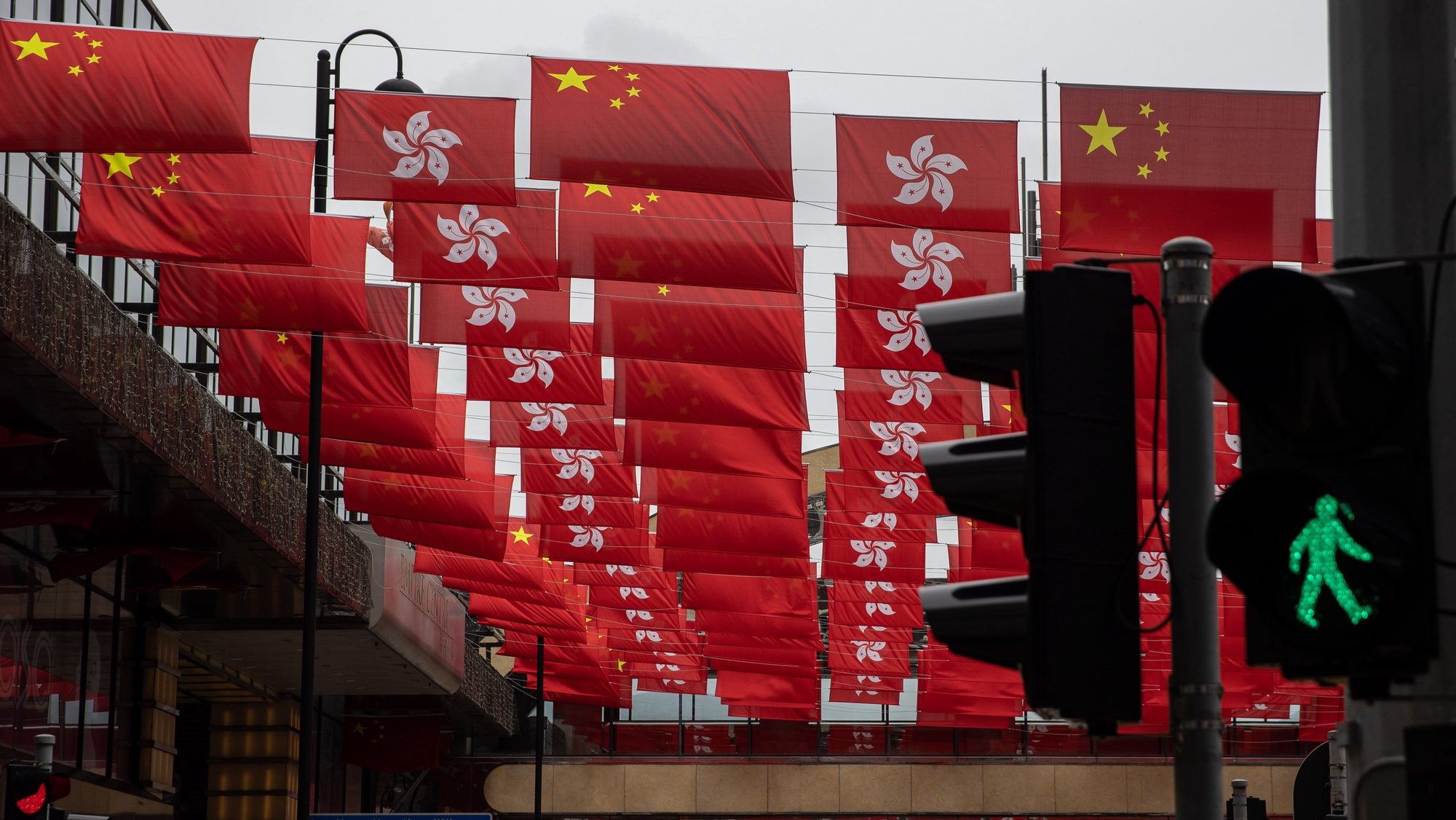 epa09307087 Flags of the Peopleâ€™s Republic of China and the Hong Kong SAR are displayed in a street in Hong Kong, China, 28 June 2021. China, Hong Kong and Macau will celebrate the 100th anniversary of the founding of the Chinese Communist Party on 01 July 2021.  EPA/JEROME FAVRE