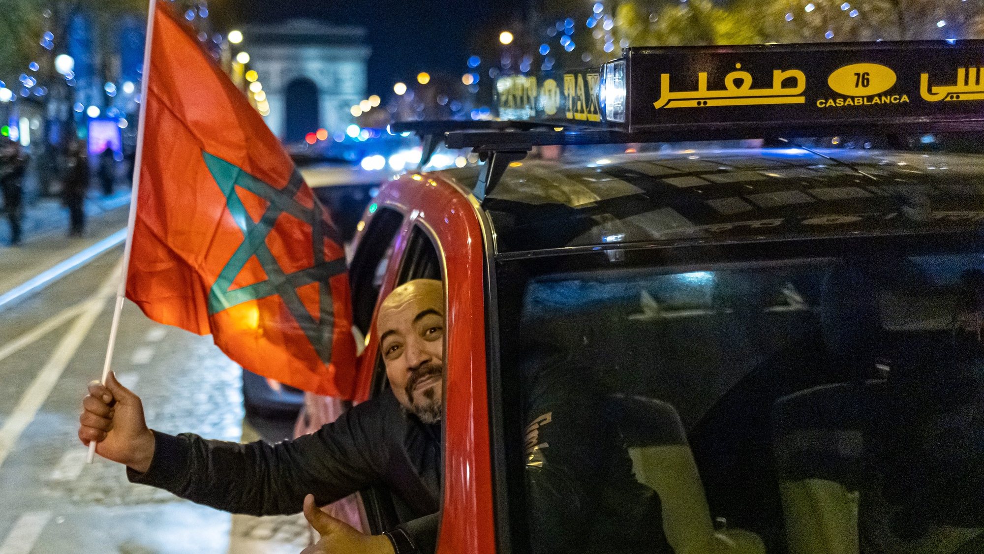 epa10359788 Supporters of Morocco celebrate their team winning the FIFA World Cup 2022 quarter final match between Morocco and Portugal on the Champs Elysees in Paris, France, 10 December 2022.  EPA/CHRISTOPHE PETIT TESSON