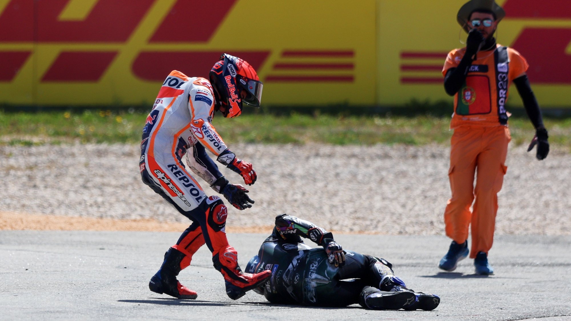Spanish MotoGP rider Marc Marquez (L) of Repsol Honda Team tries to help Portuguese MotoGP rider Miguel Oliveira of CryptoDATA RNF MotoGP Team after a crash during the MotoGP race at the Motorcycling Grand Prix of Portugal at Algarve International race track, Portimao, south of Portugal, 26 March 2023. NUNO VEIGA/LUSA