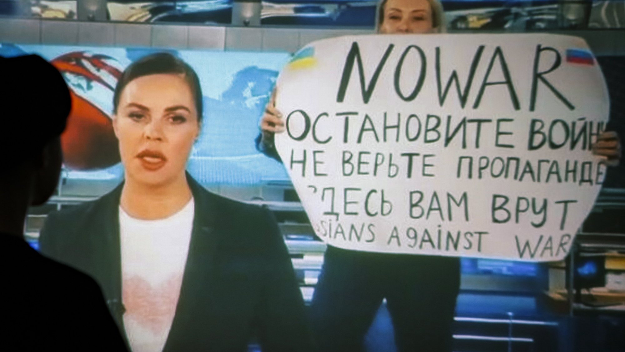 epa09840189 (FILE) - A woman watches a recorded feed of the Russian Channel One&#039;s evening news broadcast TV show in which an employee enters Ostankino on-air TV studio with a poster reading &#039;&#039;No War. Stop the war. Don&#039;t believe the propaganda. You are being lied to here&quot; in Moscow, Russia, 15 March 2022 (reissued 21 March 2022). The on-air protest was staged on 14 March by Marina Ovsyannikova, who worked as an editor. She was taken to the Ostankino police department. More than three million Ukrainians became refugees, around 700 civilians were killed and over 1.000 more inured in the month-long conflict, the United Nations said.  EPA/DSK  ATTENTION: This Image is part of a PHOTO SET